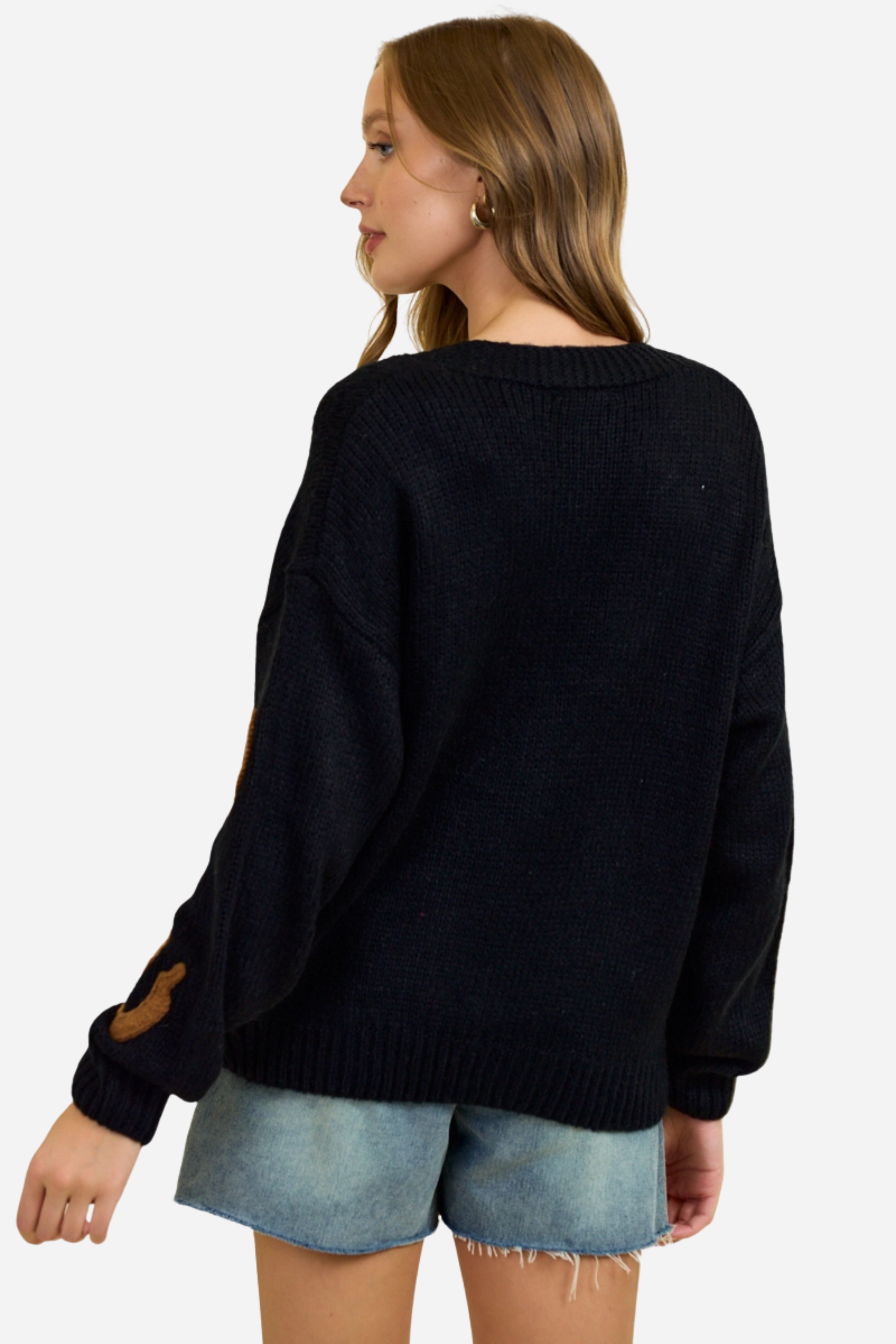 Black chunky knit cardigan with oversized brown horseshoe patches, button-front closure and deep V-neckline, styled casually with denim shorts for a relaxed equestrian-inspired look. equestrian cardigan, horseshoe print sweater, chunky knit cardigan, women’s equestrian fashion, cozy barn outfit, western inspired cardigan, horse lover gift, oversized knit sweater, casual equestrian style, layered fall equestrian look, stylish barn wear, country chic cardigan, horse themed apparel, rustic western sweater