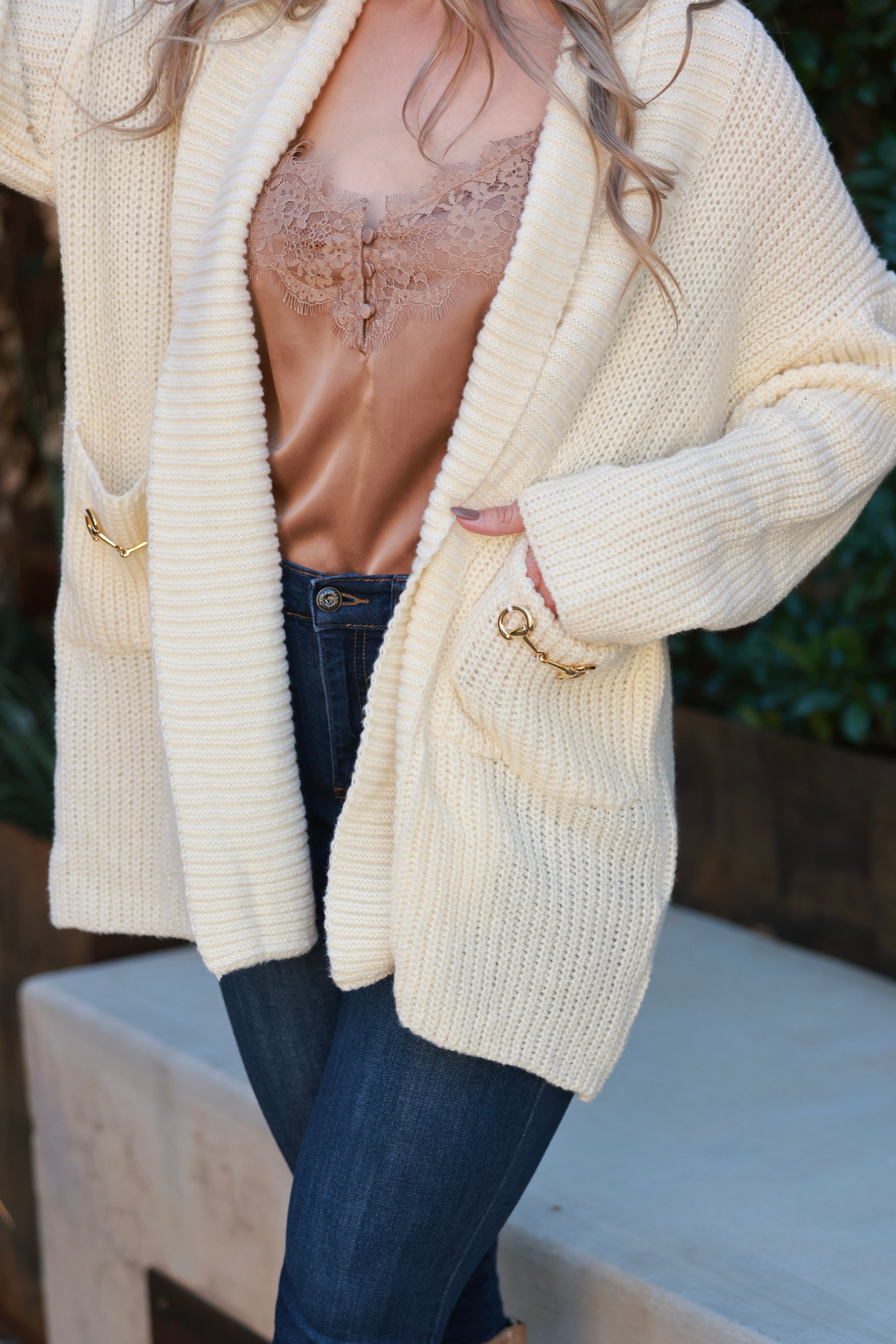 Elegant oversized equestrian cardigan in plush chunky knit with wide fold-over collar and front pockets adorned with gold horse bits. Cozy, luxurious open-front sweater inspired by classic horse girl style — the Aimee Bit Cardigan from Stylish Equestrian.
