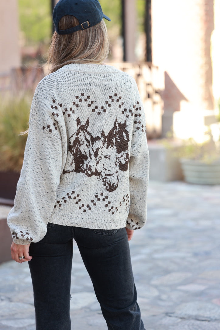 Person wearing a sweater with horse designs outdoors - Horse graphic cardigan, Western button down sweater, Equestrian fall knit, Oatmeal horse print cardigan, Cowgirl boutique sweater
