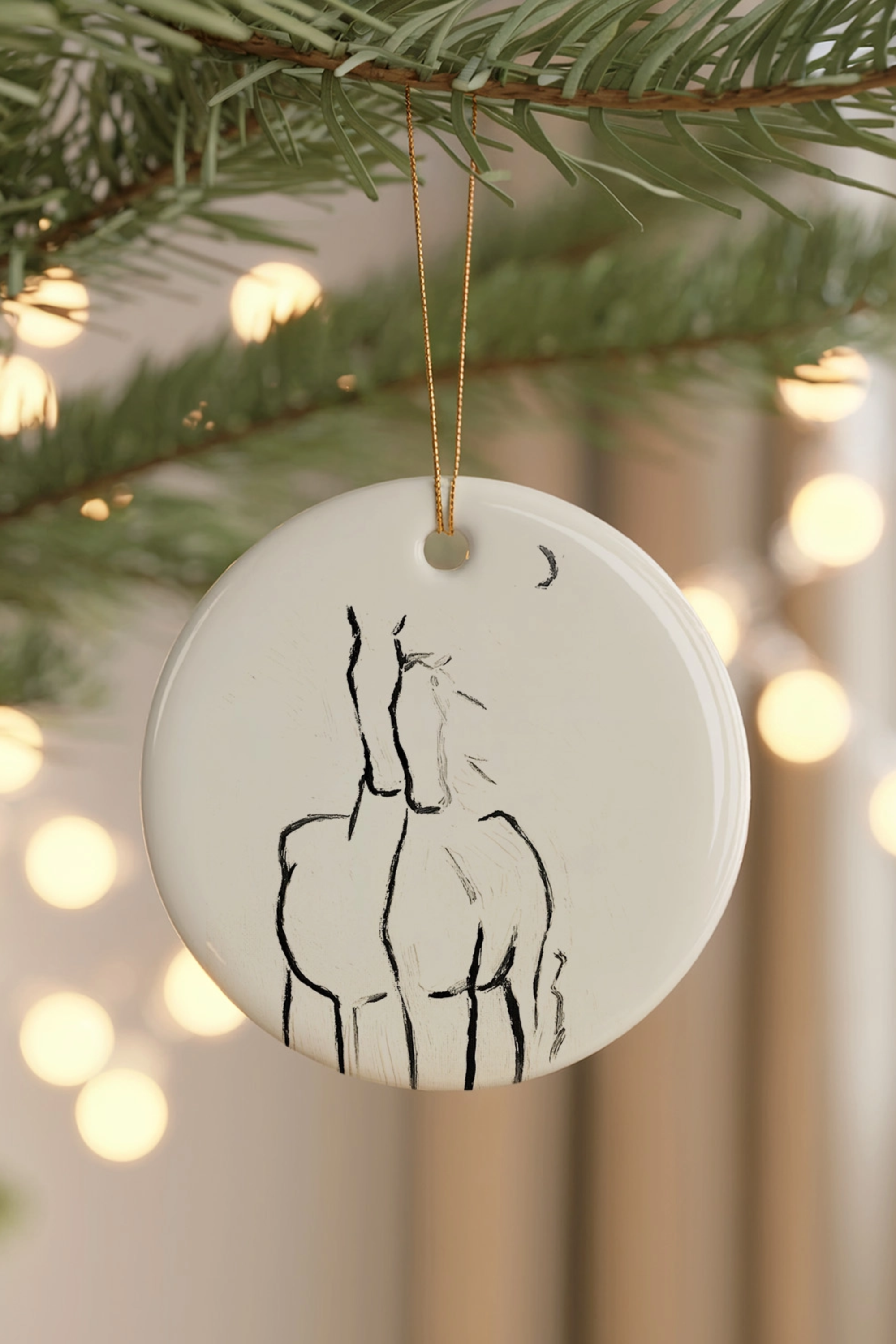 By The Crescent Ornament — ceramic equestrian-inspired Christmas ornament featuring original horse artwork by Bettina, finished with gold tinsel. A beautiful horse-themed holiday decoration and perfect Christmas gift for equestrians and horse lovers. Made in the USA.