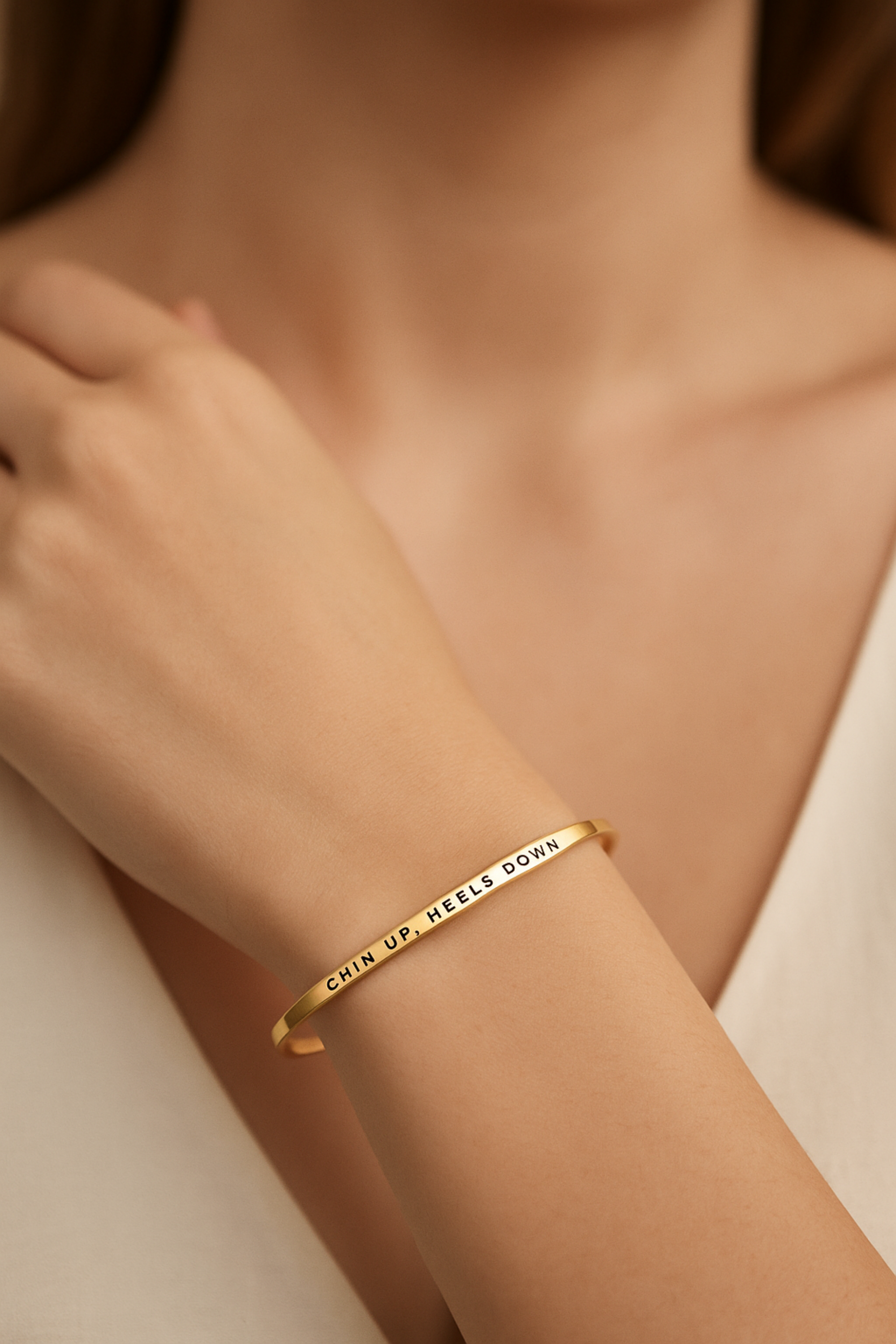 "Chin Up, Heels Down” bangle bracelet in gold or silver, crafted from stainless steel with a sleek, adjustable design. Tarnish-resistant and 18k gold dipped, this equestrian-inspired accessory makes a meaningful gift for horse lovers.