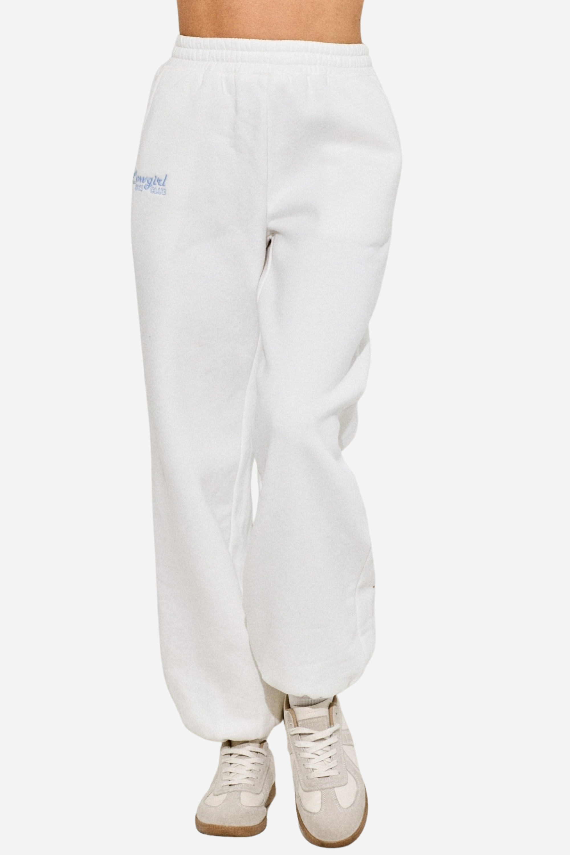 Cowgirl Ski Club Embroidered Sweatpant — ultra-soft fleece jogger-style pants blending western flair with après-ski charm. Features a powder-blue embroidered cowgirl graphic on the front right leg, elastic waistband, two side slit pockets, and a back pocket for comfort and style. Perfect cozy bottoms for horse girls and western fashion lovers. western cowgirl embroidery detail, horse girl apparel, equestrian clothing, western riding sweatpants, skiing cowgirl loungewear, cozy fleece joggers