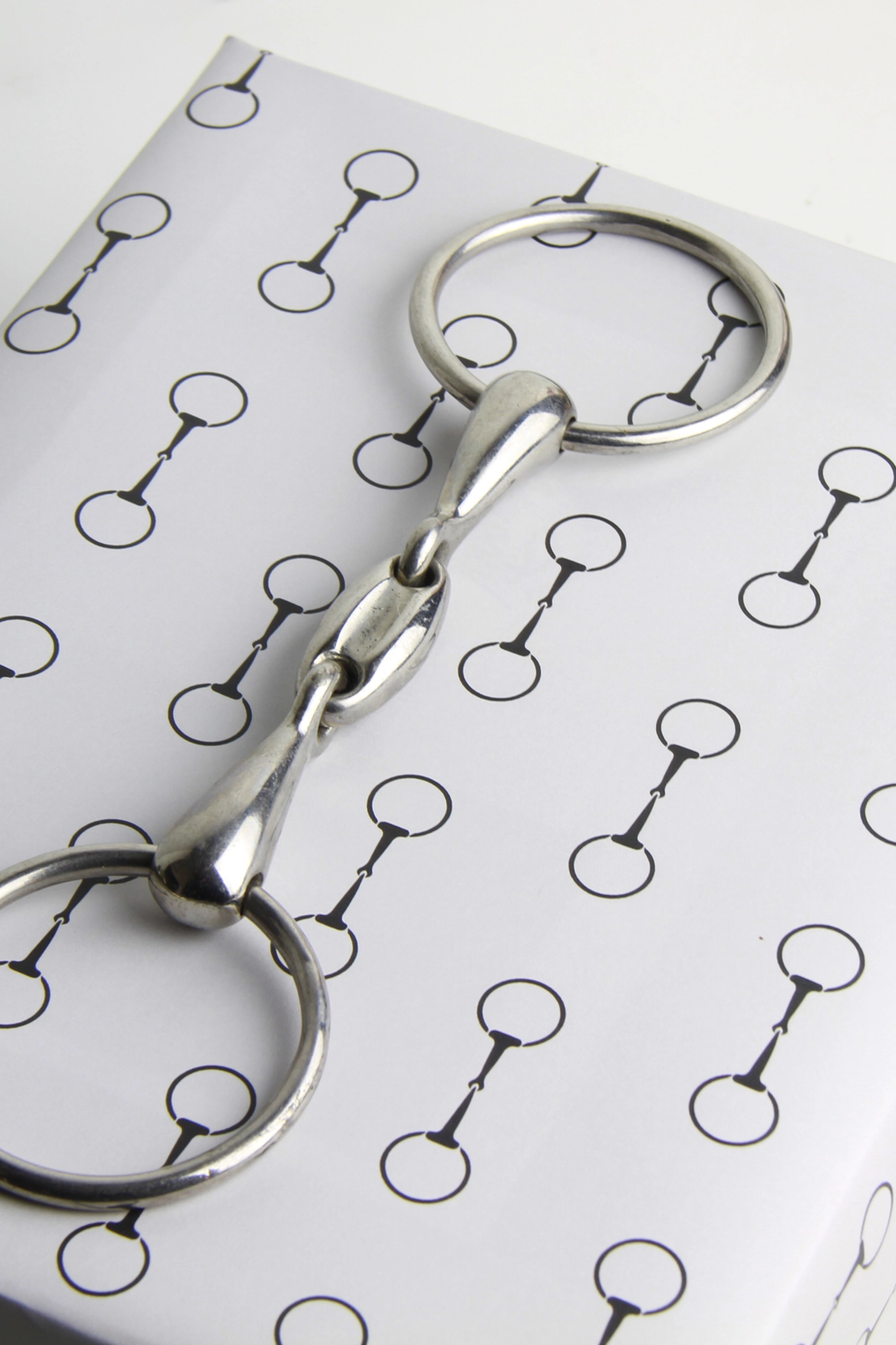 Elegant equestrian gift wrapping paper set featuring a repeating black horse bit pattern on premium textured white paper. Luxury horse-themed gift wrap sheets made in the USA—perfect for horse lovers, equestrian gifts, and stylish holiday packaging.