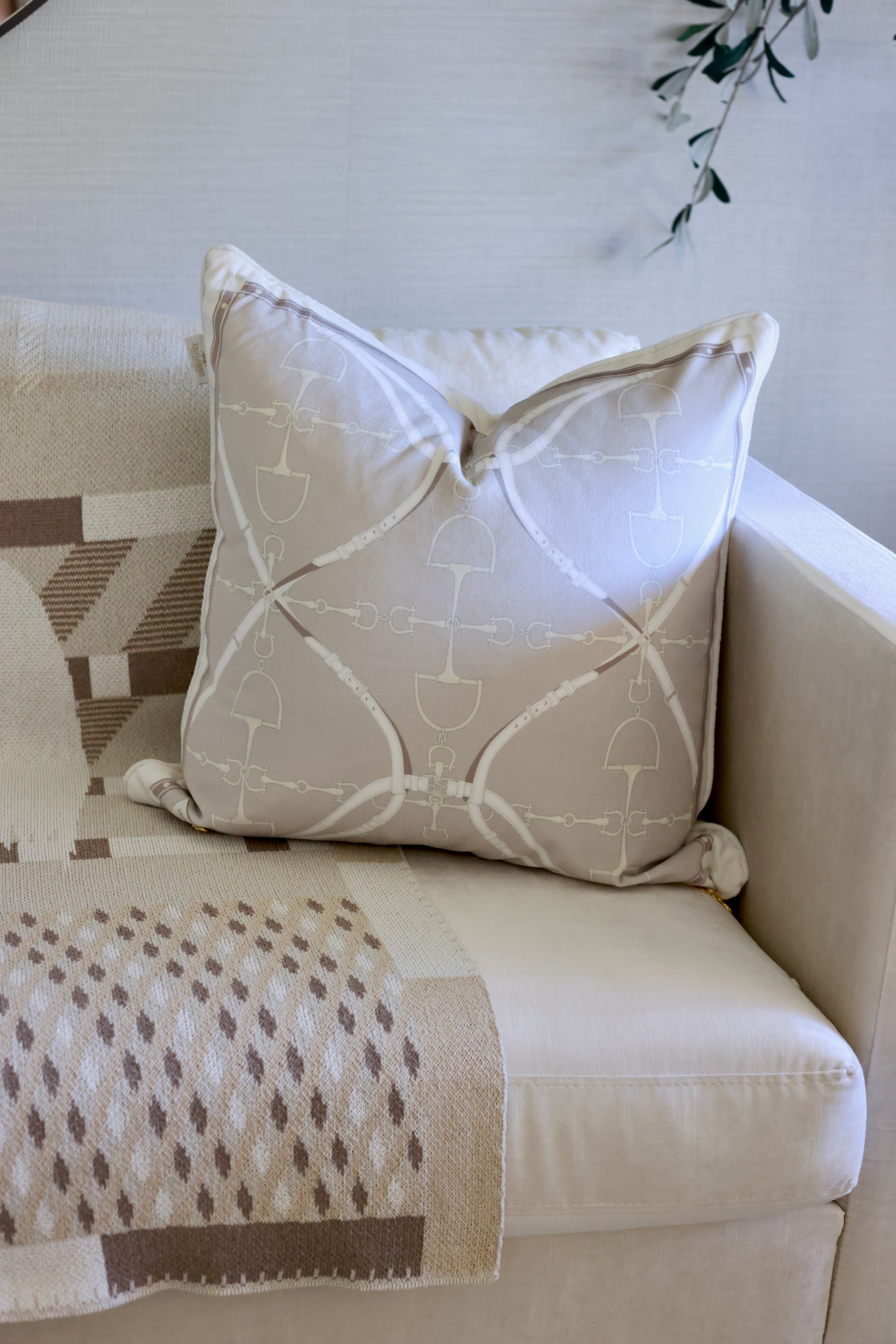 D-Ring Velvet Pillow – Putty by Stylish Equestrian, a luxurious 22x22 brushed velvet pillow featuring a modern equestrian D-ring bit pattern in soft neutral hues. Includes insert with side zip access and solid velvet backing for a refined finish. Perfect for adding equestrian charm and sophistication to any home décor. equestrian home decor and interior design, horse themed pillow, D-ring bit pillow, luxury velvet cushion, equestrian home furnishing, neutral horse decor, elegant equestrian accent