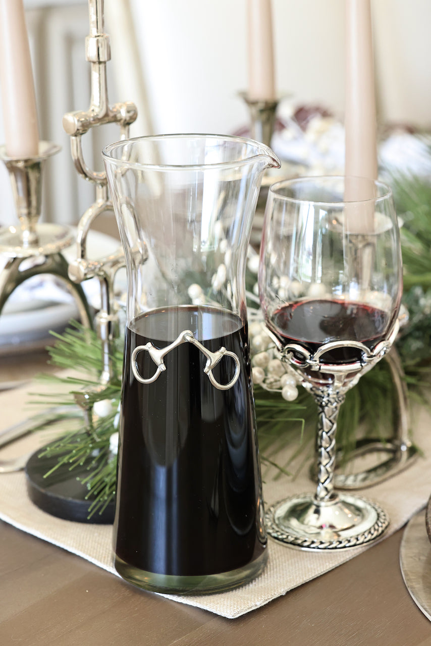 Dawson Carafe by Arthur Court featuring a 28 oz clear glass body accented with a crafted pewter horse bit. A sophisticated equestrian-inspired carafe designed to enhance beverages and elevate any table setting.
