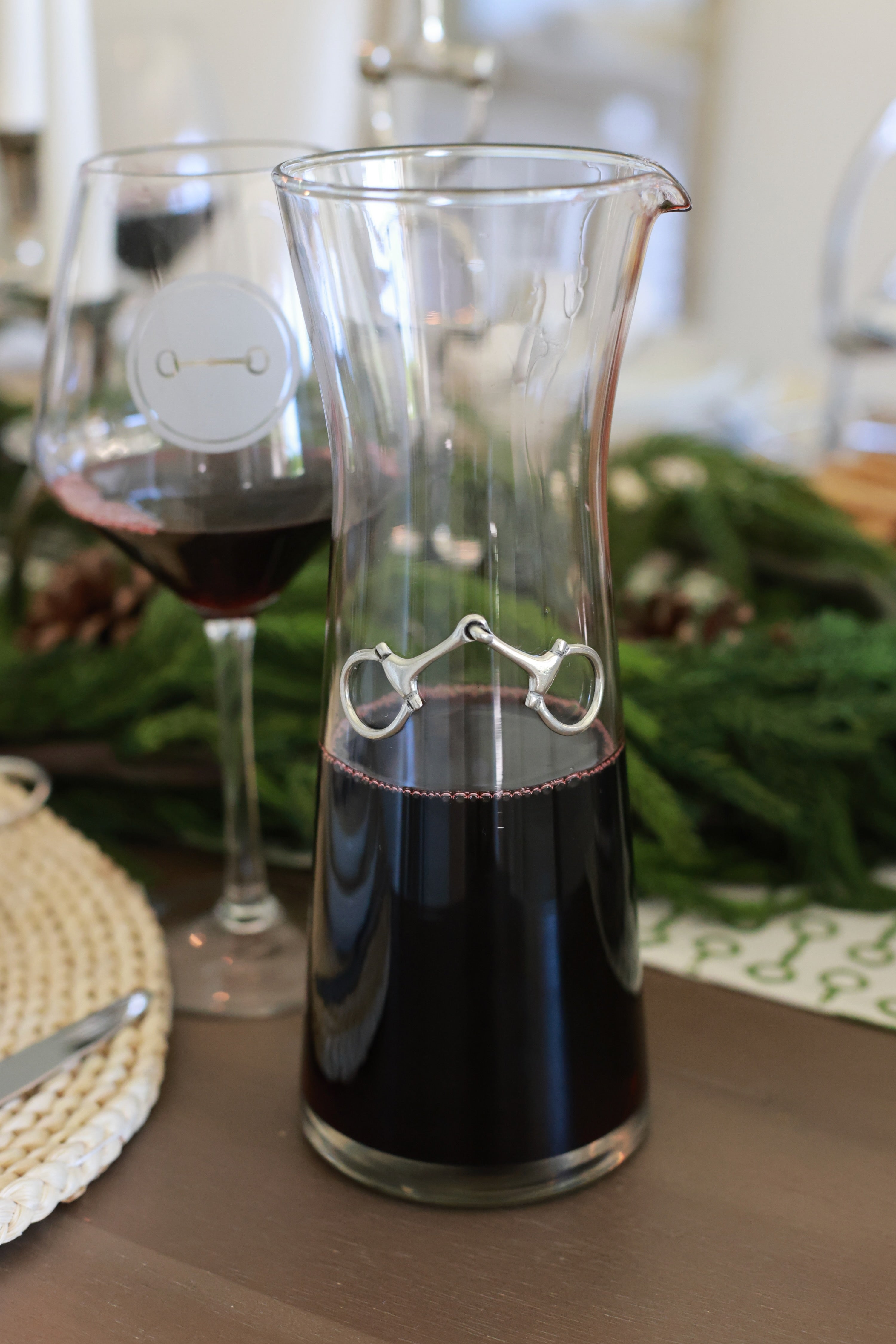 Dawson Carafe by Arthur Court featuring a 28 oz clear glass body accented with a crafted pewter horse bit. A sophisticated equestrian-inspired carafe designed to enhance beverages and elevate any table setting.