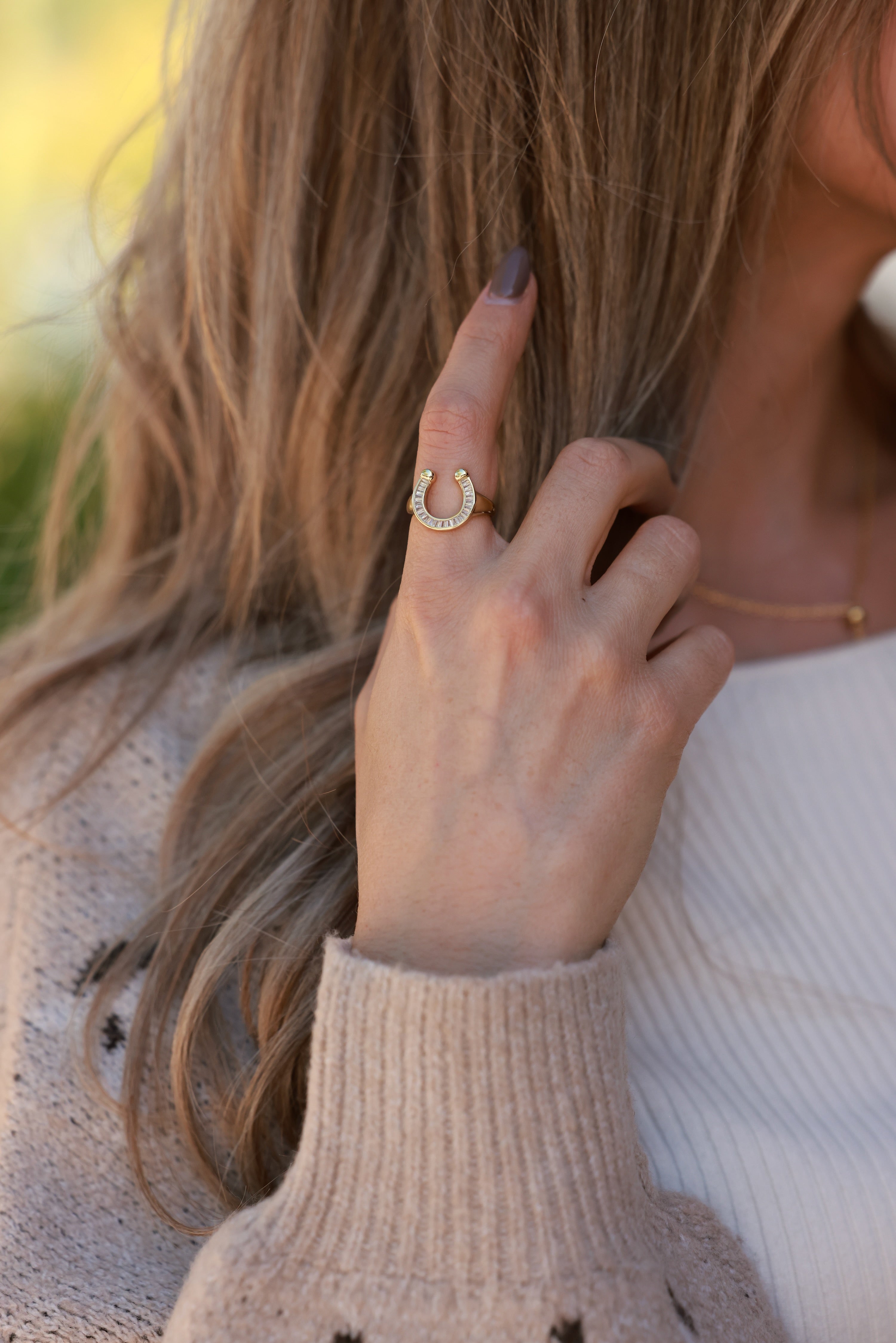 Elegant 18k gold-plated stainless steel horseshoe signet ring with sparkling CZ details. Water- and tarnish-resistant, hypoallergenic equestrian jewelry — a modern, playful twist on the classic horseshoe symbol.