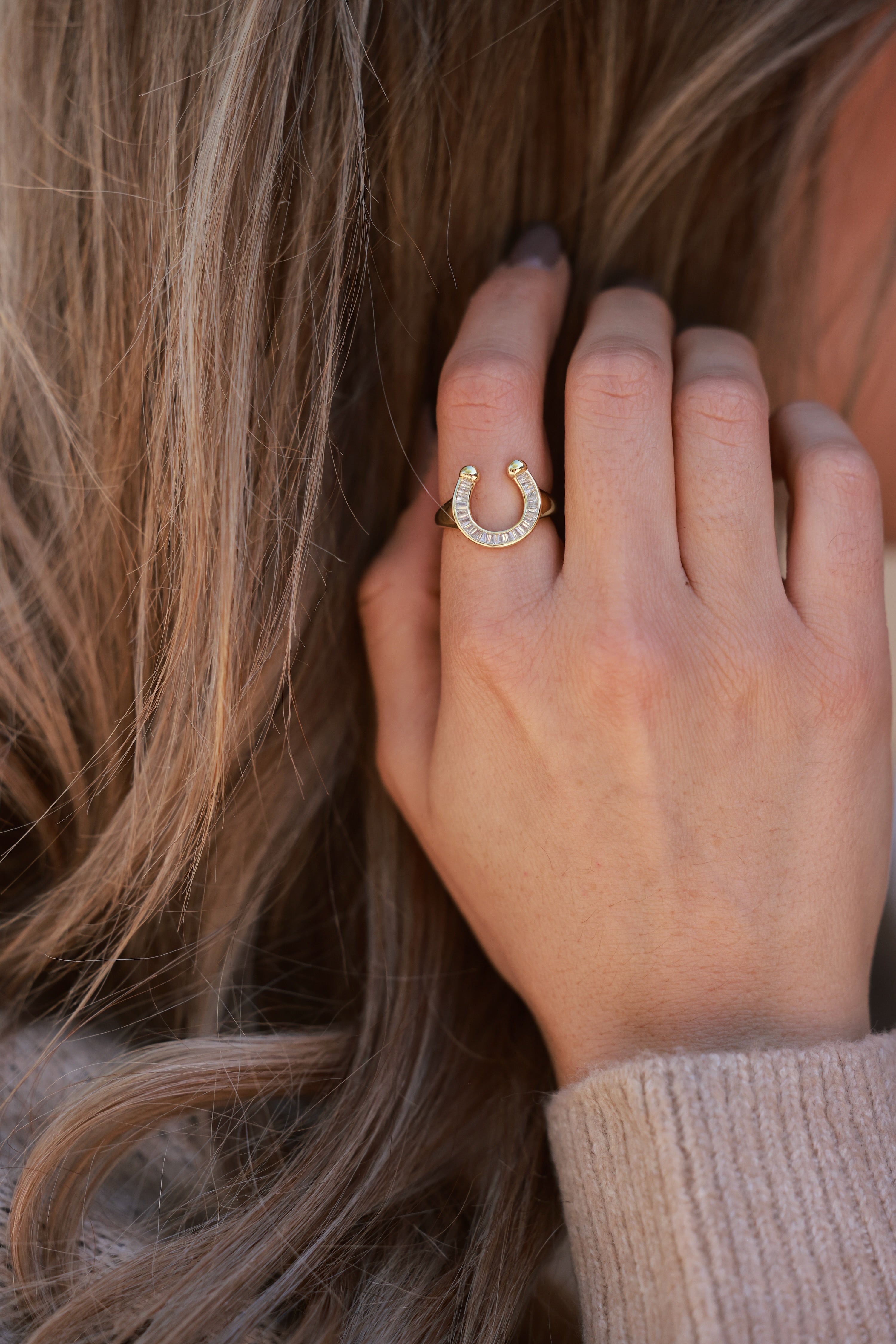 Elegant 18k gold-plated stainless steel horseshoe signet ring with sparkling CZ details. Water- and tarnish-resistant, hypoallergenic equestrian jewelry — a modern, playful twist on the classic horseshoe symbol.