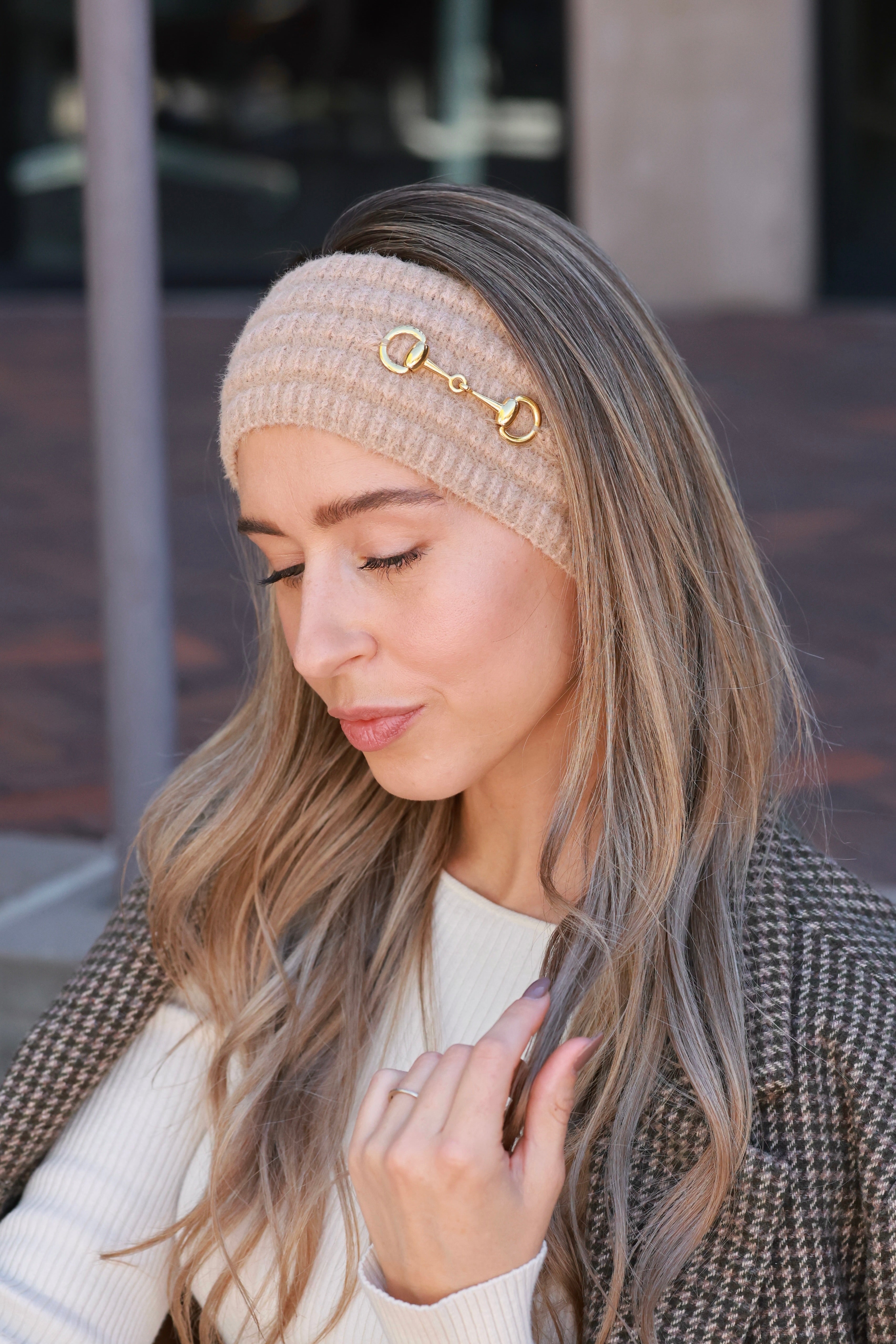 Taupe Elsie Knit Headband crafted from soft, stretchy knit with a gold bit accent. Cozy equestrian cold-weather accessory designed for comfort and style — perfect for barn mornings, trail rides, or everyday wear.