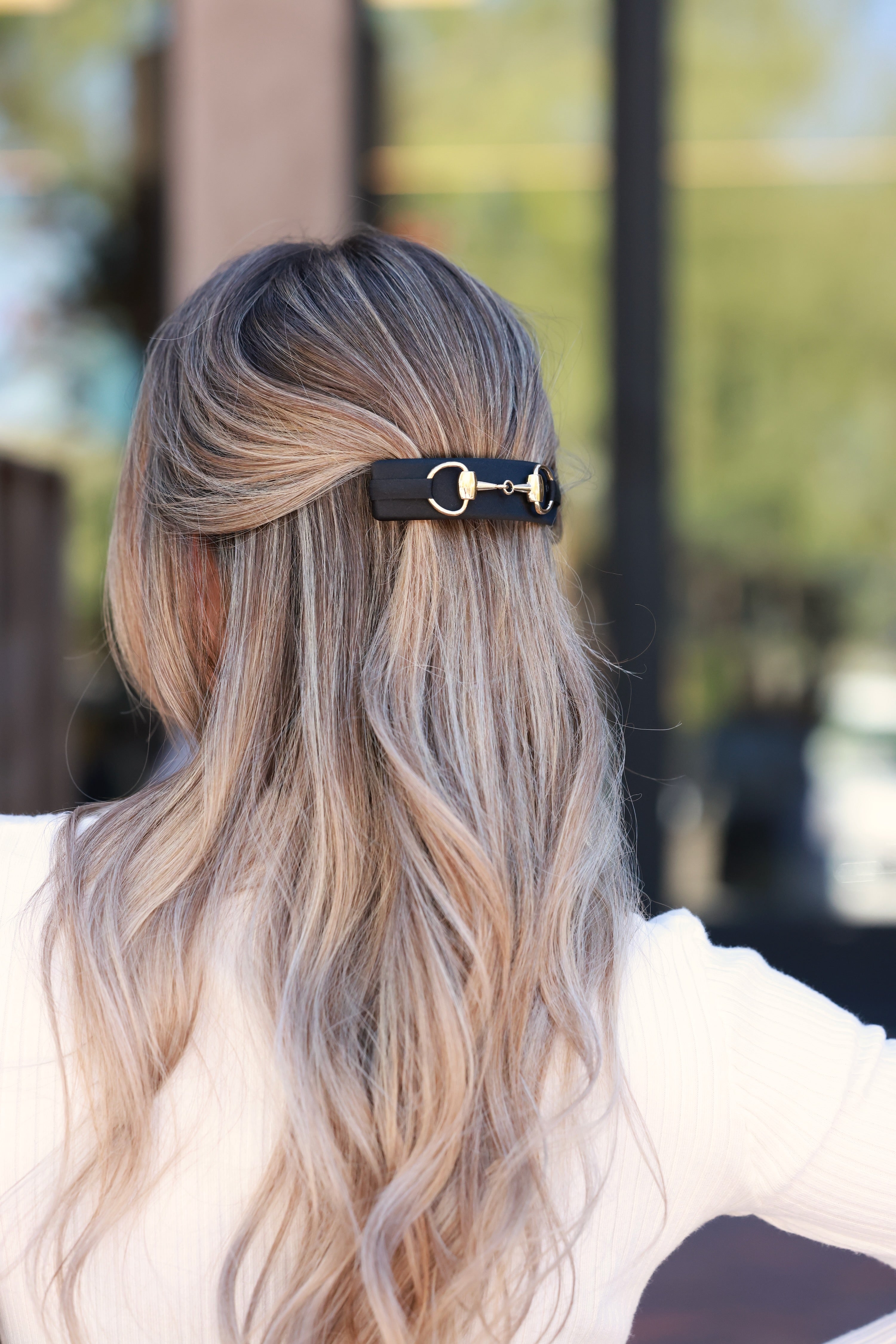 Black Hattie Bit Silk Barrette handcrafted in 100% silk charmeuse, featuring a large gold snaffle bit detail and sturdy clasp for thick hair. Elegant equestrian-inspired accessory that adds everyday chic and timeless sophistication to any hairstyle.