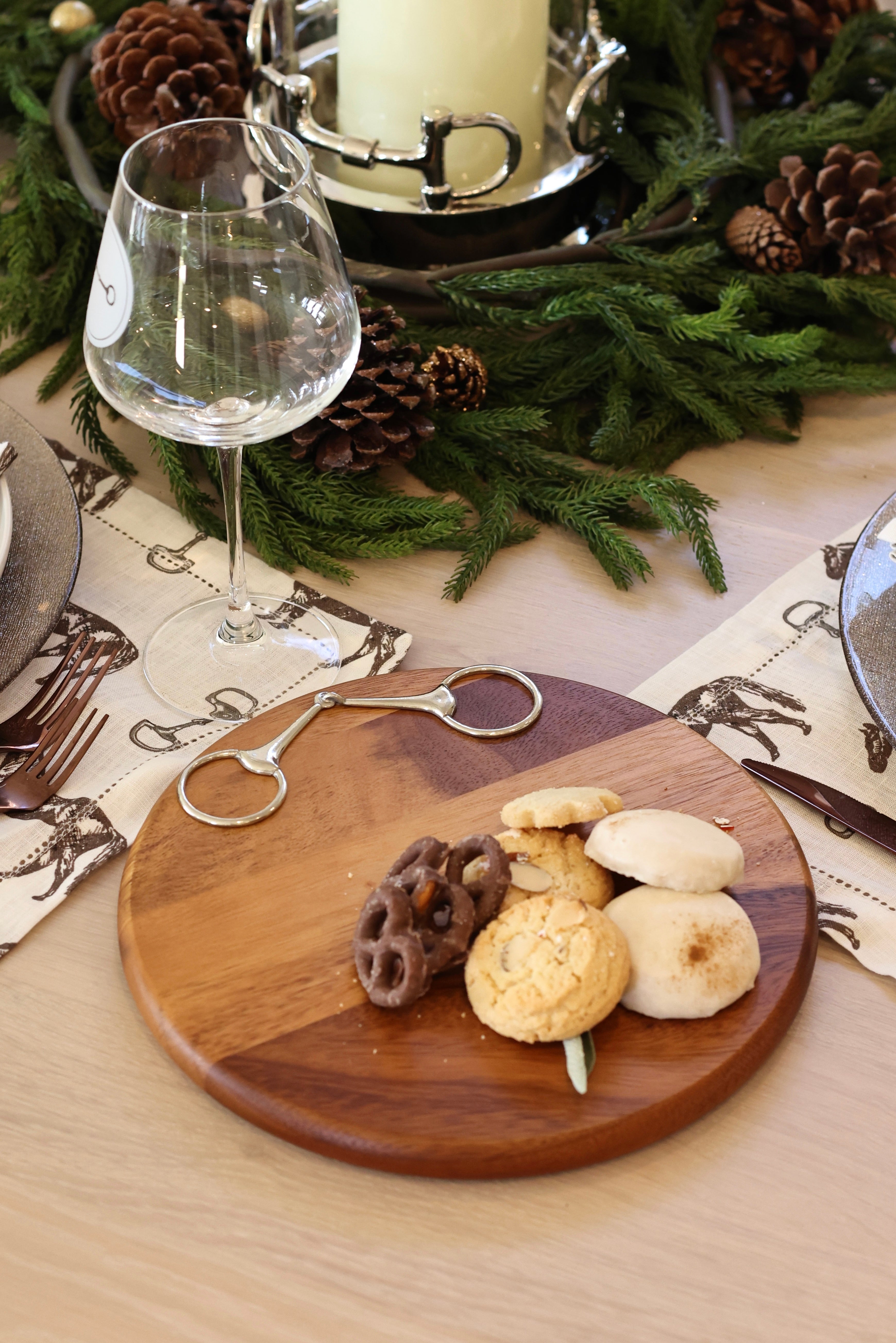 Henry Bit Serving Board by Arthur Court featuring a round 10-inch acacia wood board accented with a pewter horse bit detail. A refined equestrian-inspired serving piece perfect for charcuterie, entertaining, or gifting.