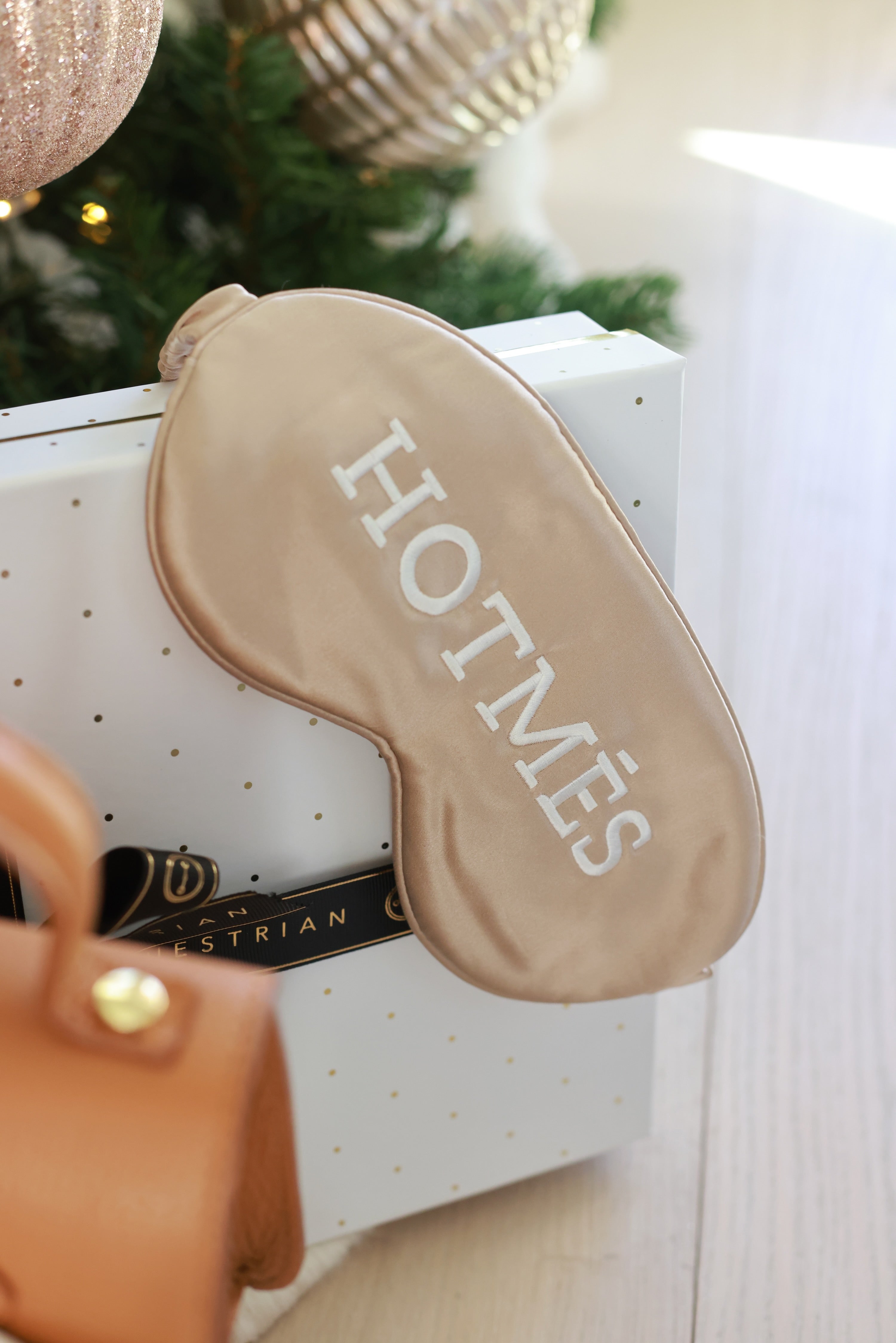 Hotmés Silk Sleep Mask made from 100% silk with front embroidery and elastic strap. Luxurious, comfortable, equestrian-inspired sleep accessory.