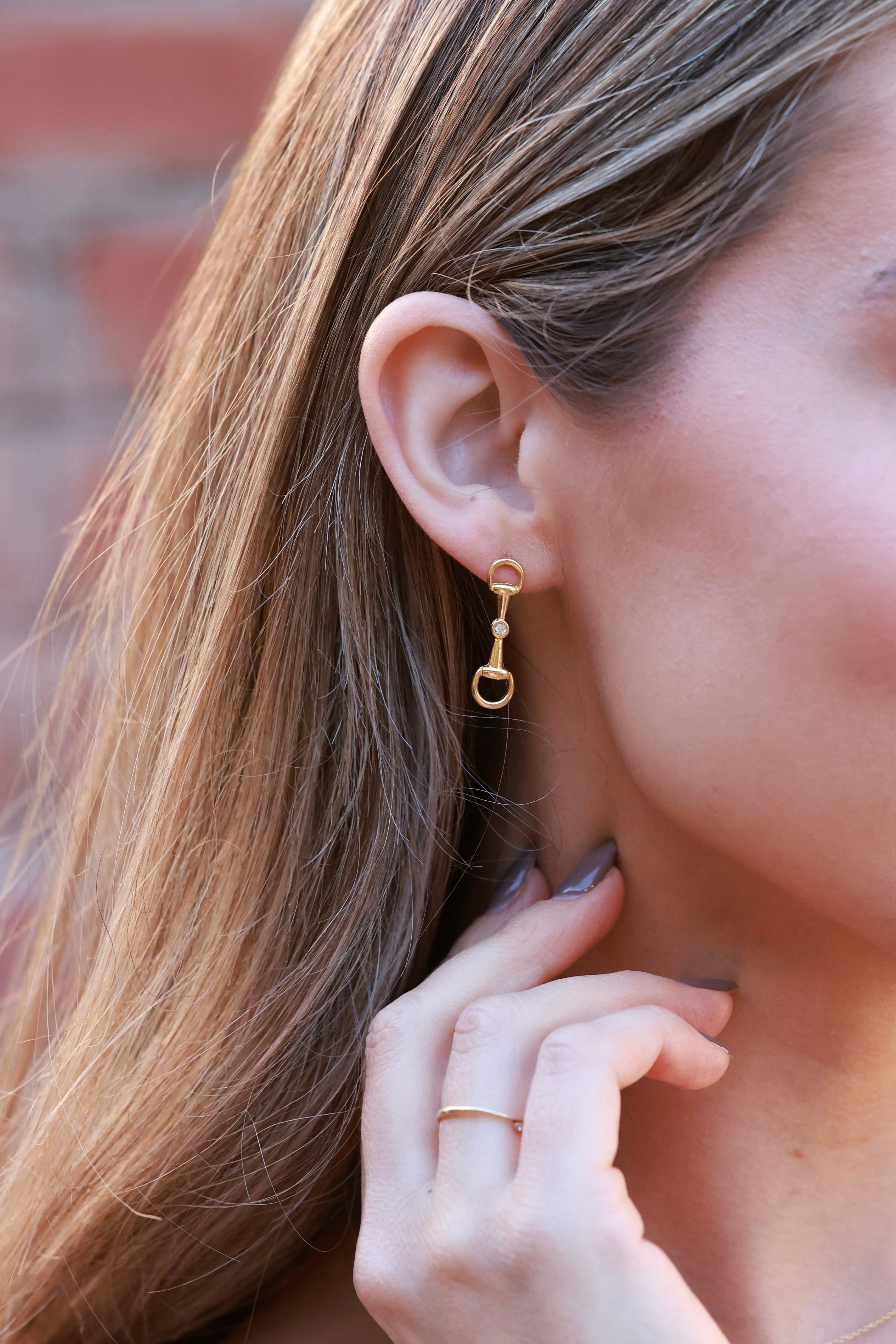 Gold equestrian bit drop earrings with crystal accents, lightweight 18k gold horse girl jewelry, dainty CZ stud earrings, elegant gift for equestrian lovers.