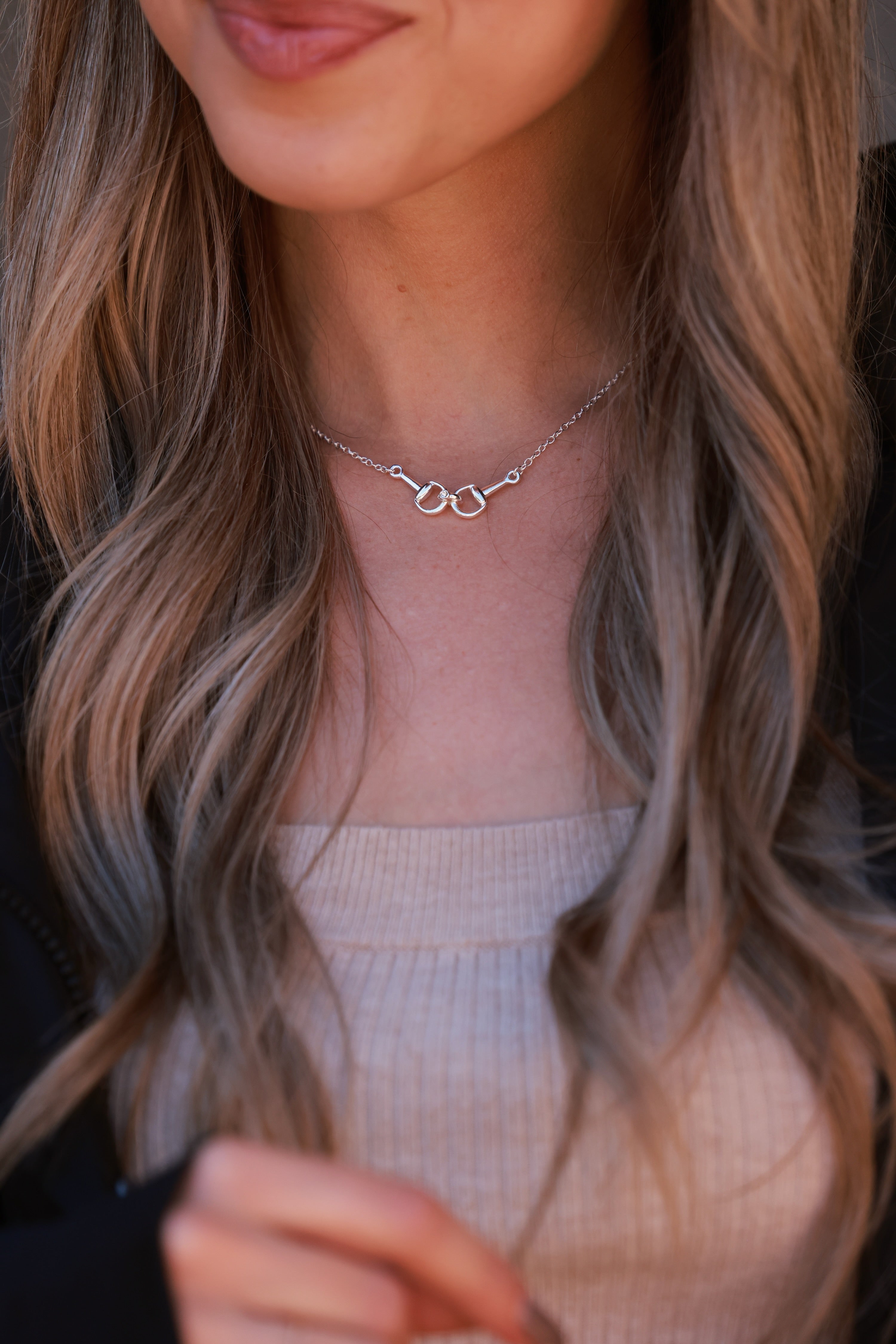 Silver necklace on a person wearing a beige top -equestrian inspired jewelry, horse girl accessory, horseshoe pendant necklace, dainty equestrian jewelry, small gifts for horse lovers