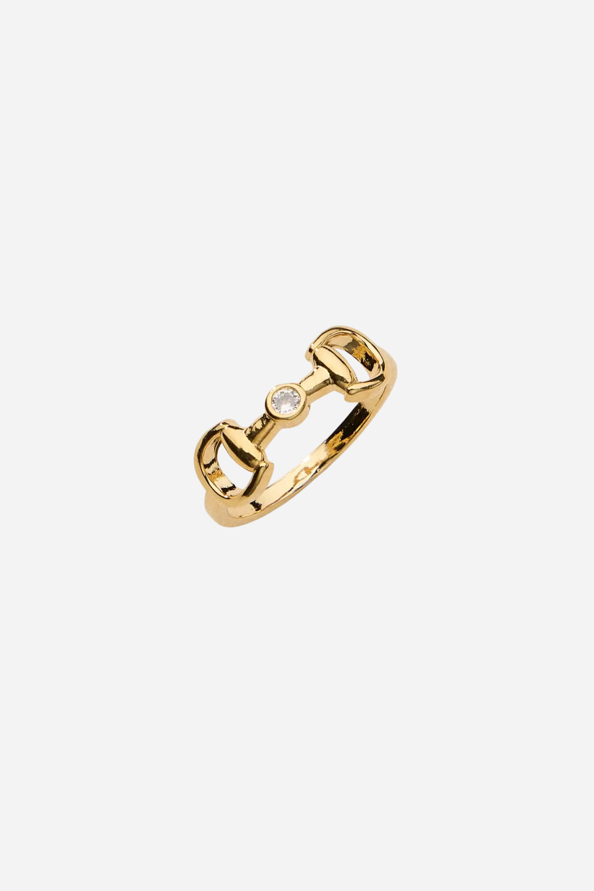 18k gold-plated equestrian horse bit ring with a bezel-set crystal accent, designed as a refined everyday statement piece.