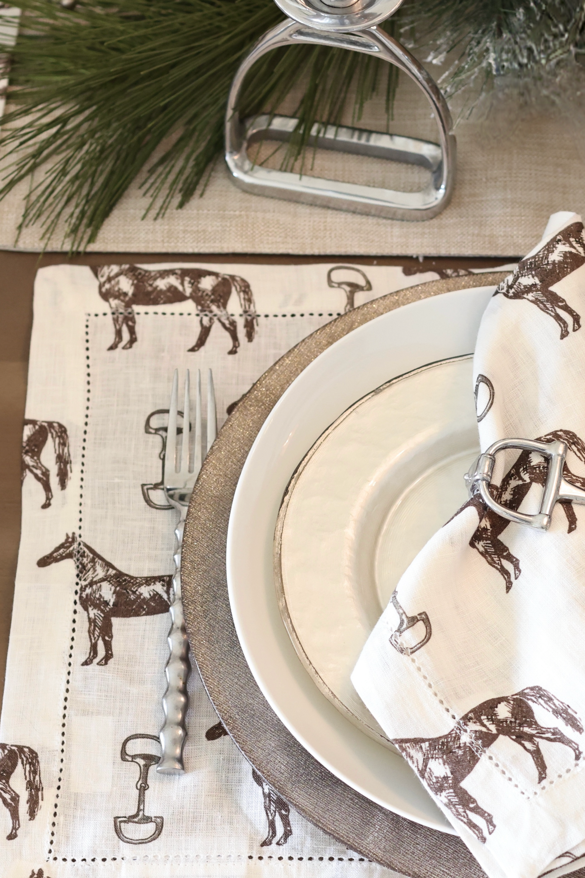 pomegranate inc stylish equestrian horse and snaffle linen placemat set Horse & Snaffle Linen Placemat Set featuring a hand-sketched design of horses and snaffle bits on white linen with a stitched border. Set of four elegant 13x19" placemats perfect for equestrian-inspired table settings.