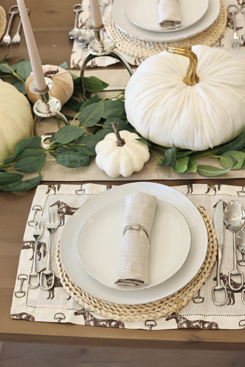 pomegranate inc stylish equestrian horse and snaffle linen placemat set Horse & Snaffle Linen Placemat Set featuring a hand-sketched design of horses and snaffle bits on white linen with a stitched border. Set of four elegant 13x19" placemats perfect for equestrian-inspired table settings.