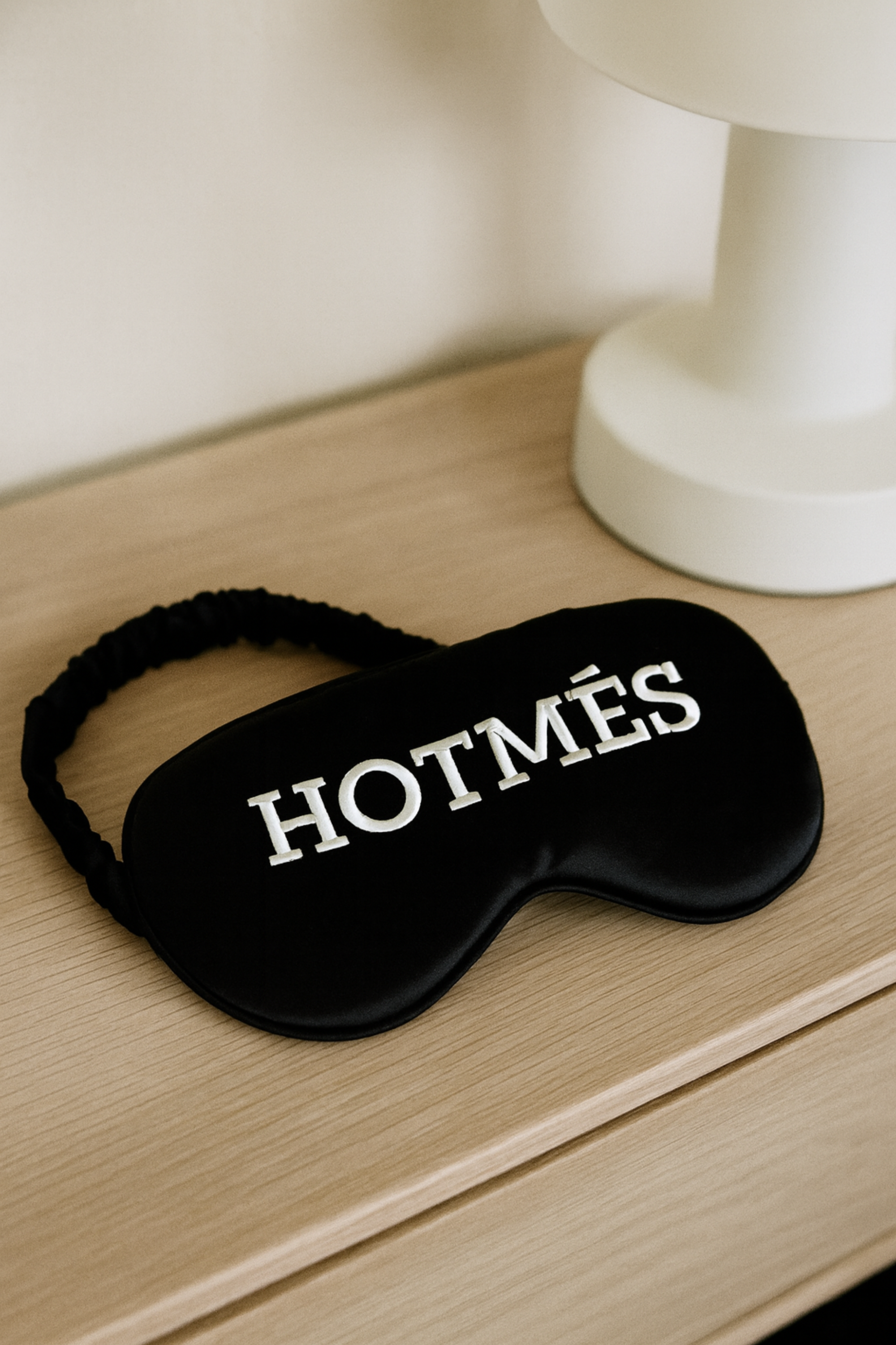 Hotmés Silk Sleep Mask made from 100% silk with front embroidery and elastic strap. Luxurious, comfortable, equestrian-inspired sleep accessory.