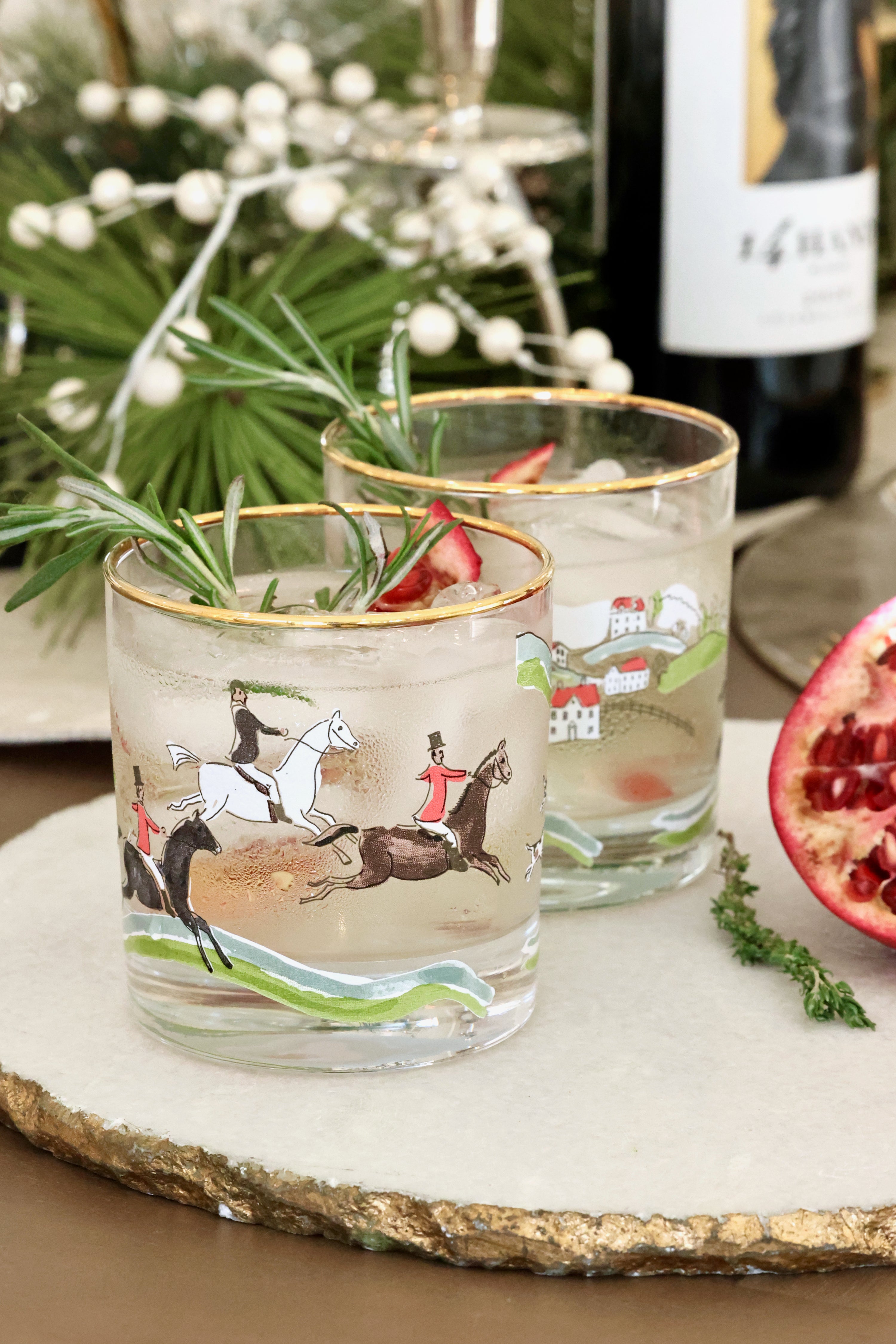 The Hunt Scene Drinking Glass Set featuring four tall glasses adorned with a detailed equestrian hunt scene and finished with elegant gold rims. A sophisticated horse-themed glassware set perfect for entertaining or gifting.