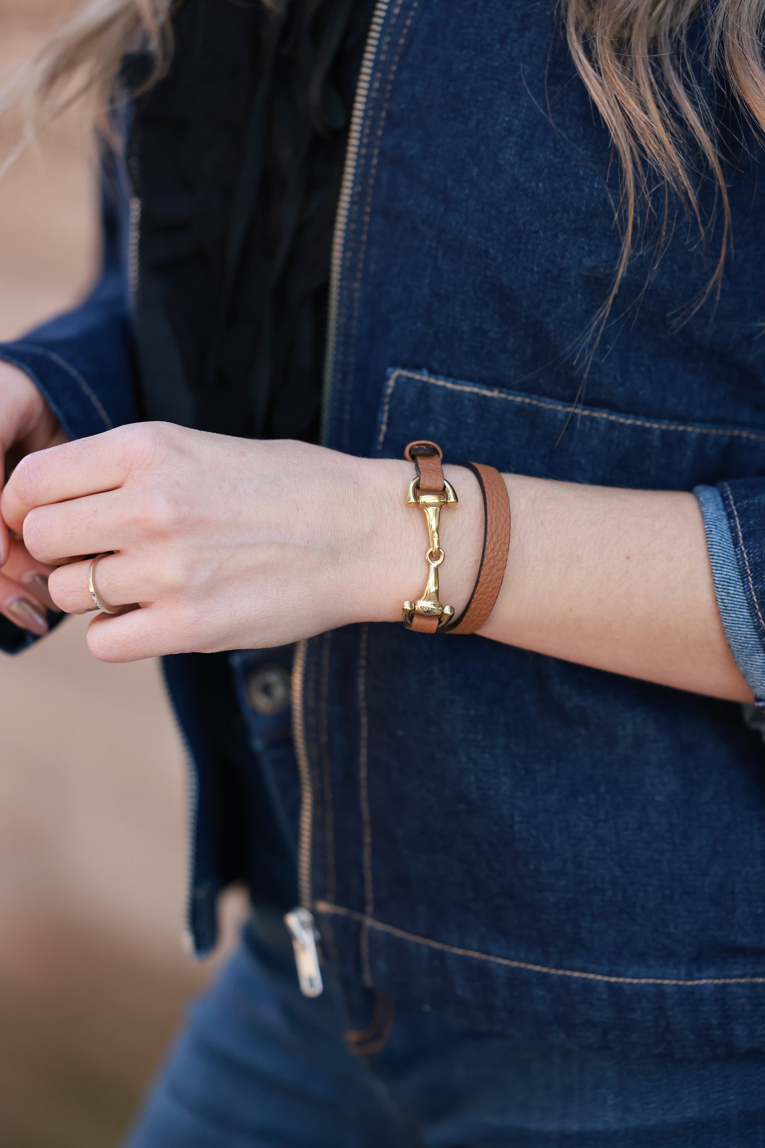 Cognac Ingrid Bit Wrap Bracelet from Stylish Equestrian x Dimacci, handmade in Germany from soft genuine leather with polished stainless steel snaffle bit hardware and adjustable buckle. Elegant, petite equestrian bracelet offering timeless sophistication for horse lovers.