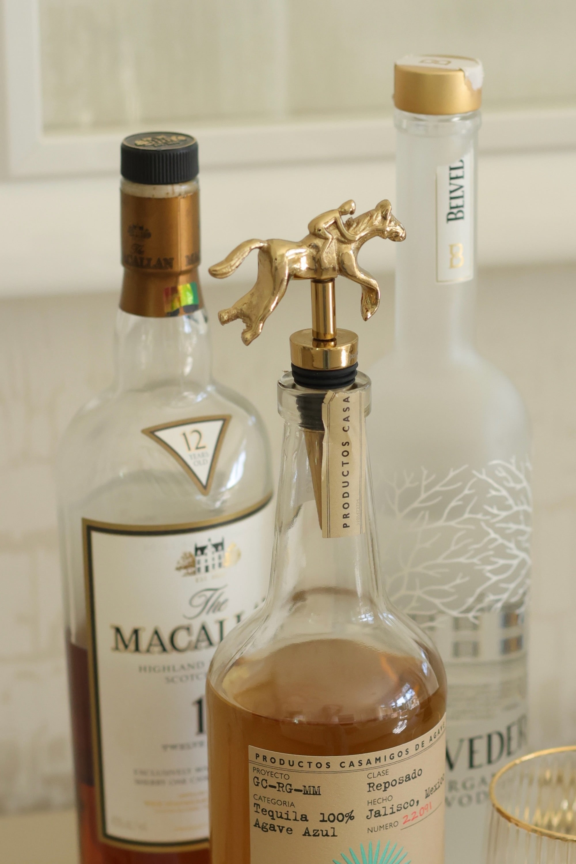 Pomegranate Jockey Bottle Stopper - Gold Elevate your entertaining with the Gold Jockey Bottle Stopper. Crafted with a charming horse & jockey design, this stopper not only preserves your wine's freshness but also adds a touch of equestrian elegance to your barware. Its durable construction ensures a secure fit, making it a delightful gift for horse lovers and wine enthusiasts alike.