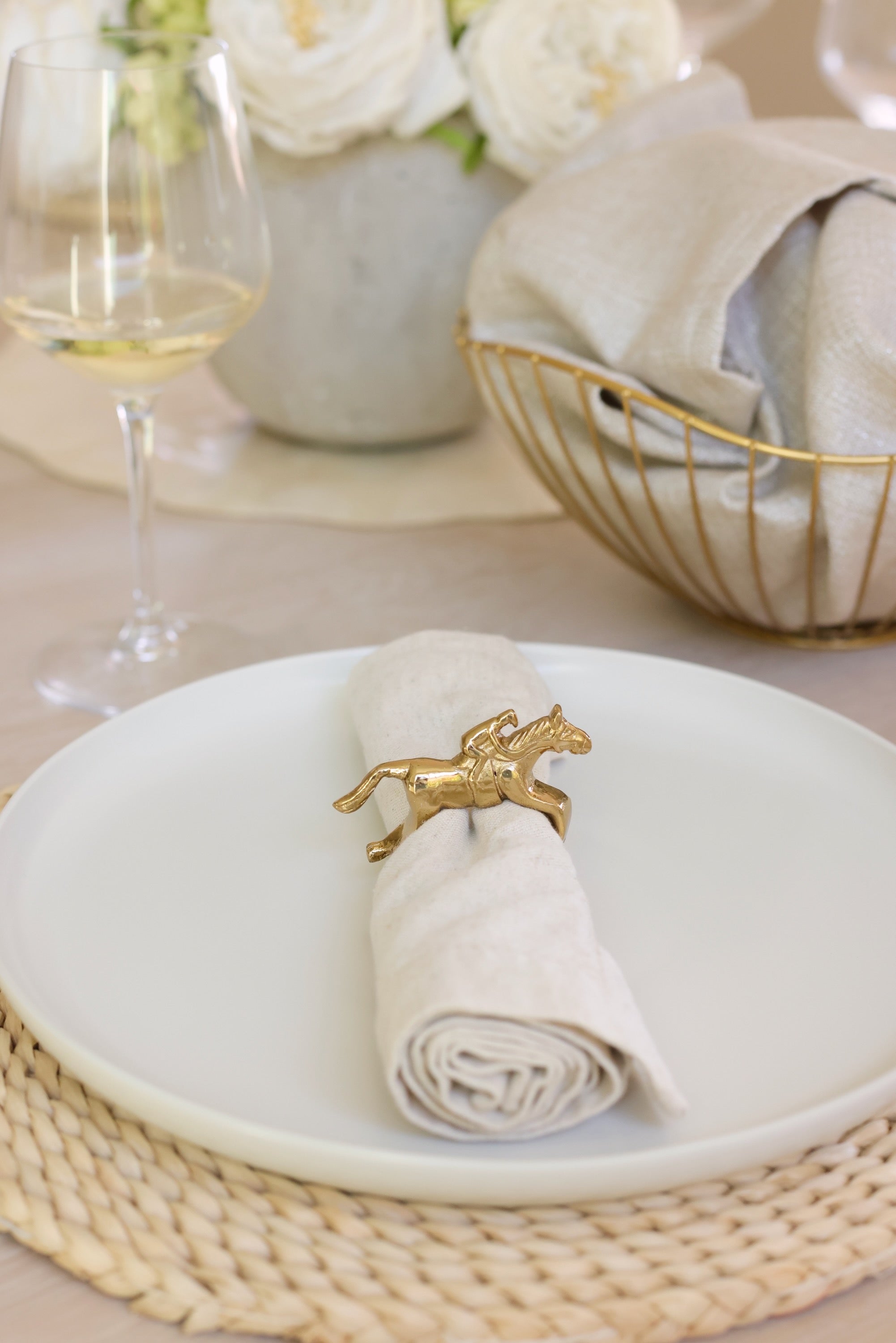 Pomegranate Jockey Napkin Ring Set - Gold Bring a touch of luxury to your table with the Gold Jockey Napkin Rings. This set of four features a stunning horse & jockey design that shines at every gathering. Ideal for formal dinners or casual brunches, these napkin rings are the perfect accessory to elevate your dining decor.