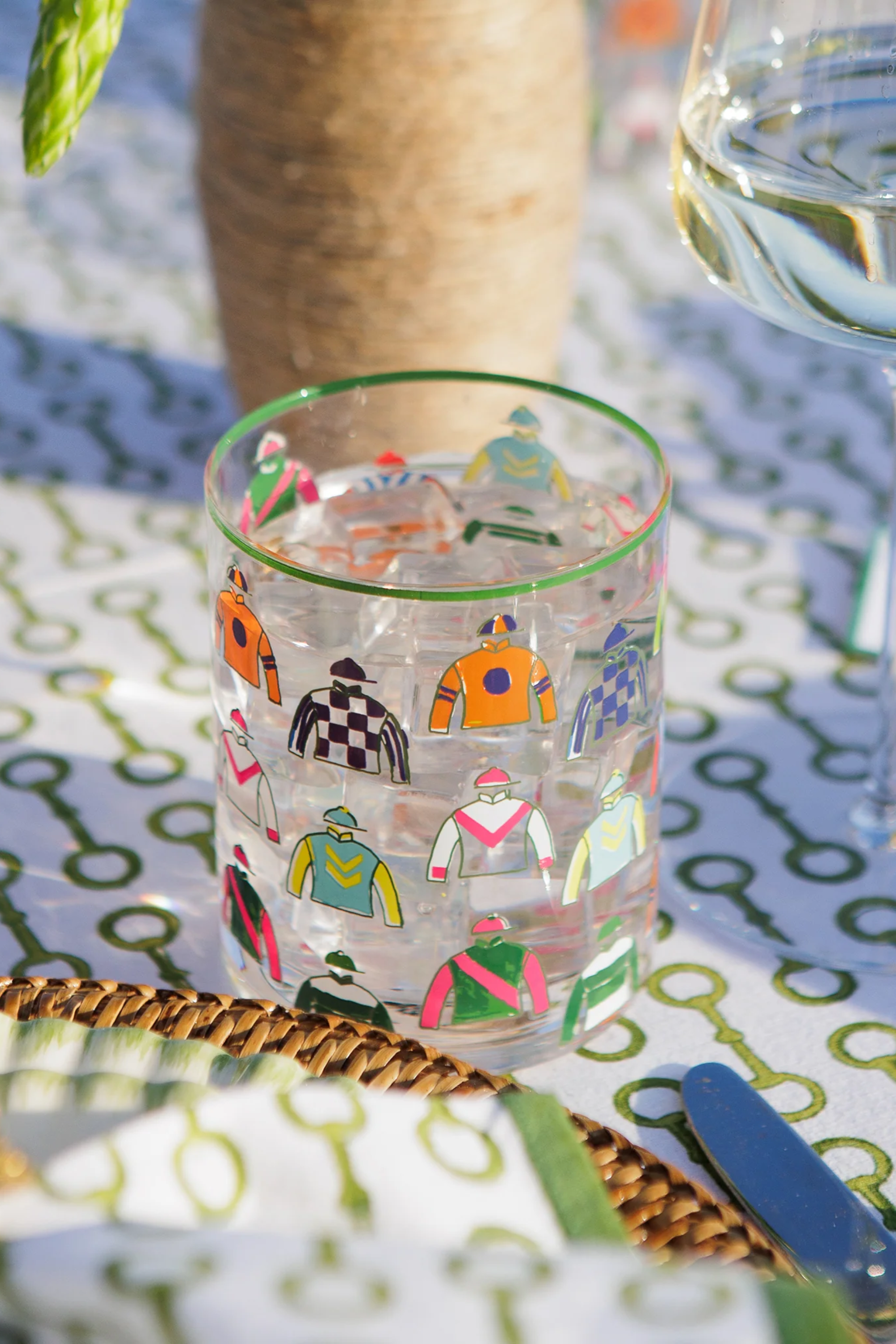 Pomegranate Jockey Silks Short Drinking Glass Set Get ready for the races with the Jockey Silks Bourbon Glass set. Each glass in this set of four is wrapped in a vibrant parade of racing silks, reminiscent of Derby Day at Churchill Downs or a crisp autumn afternoon at Keeneland. Whether you’ve got a colt in the running or you’re just here for the juleps, these glasses are a sure bet for any gathering.