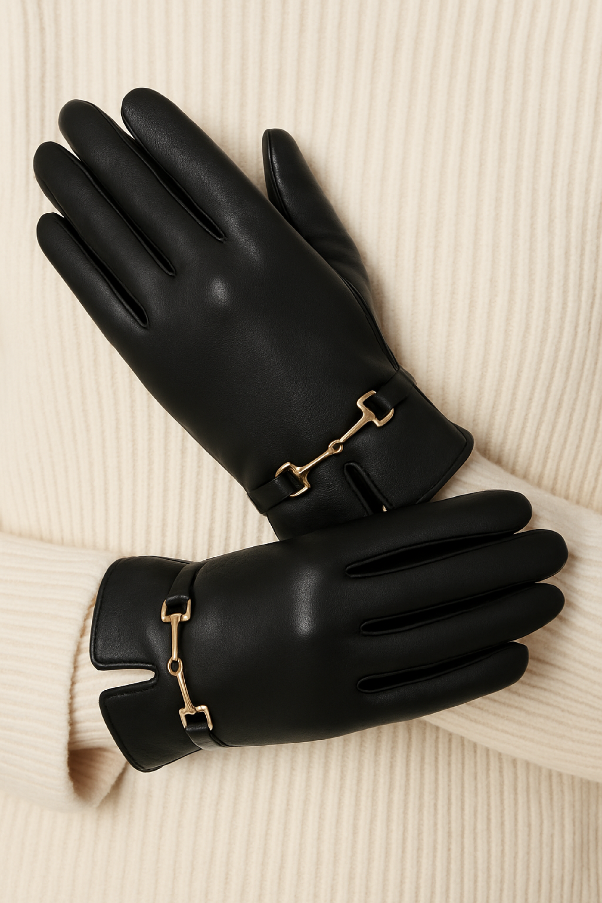 Classic black faux-leather gloves featuring a plush faux-fur lining and a gold horse bit detail at the wrist. Sophisticated equestrian-inspired design with a chic, tailored finish.