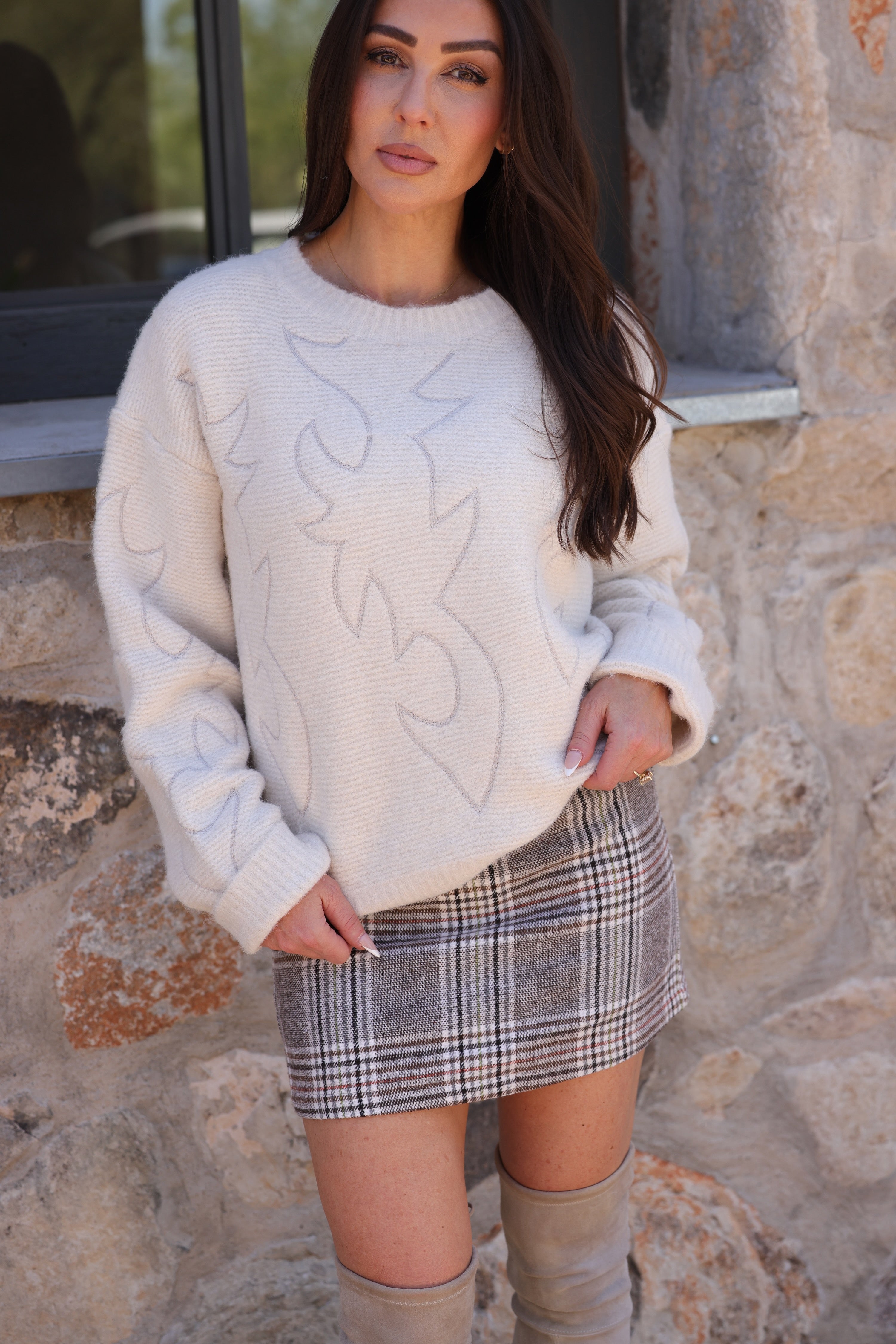 Blue B Lainey Sweater A cozy crew neck sweater featuring a unique western boots stitch pattern, perfect for adding a touch of style to your wardrobe. Crafted from a soft and warm fabric blend.