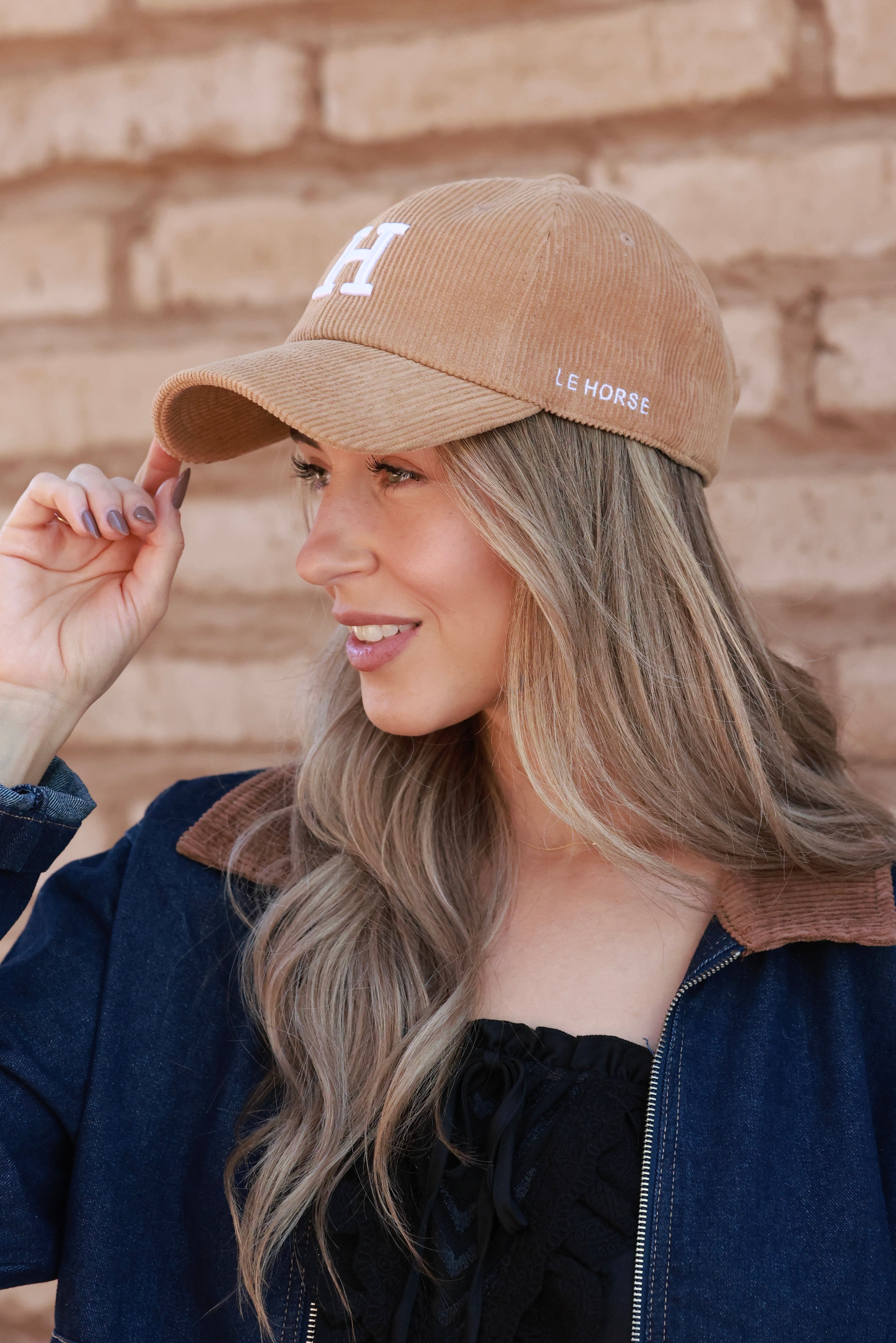 Camel Le Horse Corduroy Cap featuring trendy embroidered ‘H’ front and side Le Horse detail. Unstructured, low-profile six-panel design with pre-curved visor and adjustable strap for a comfortable fit.