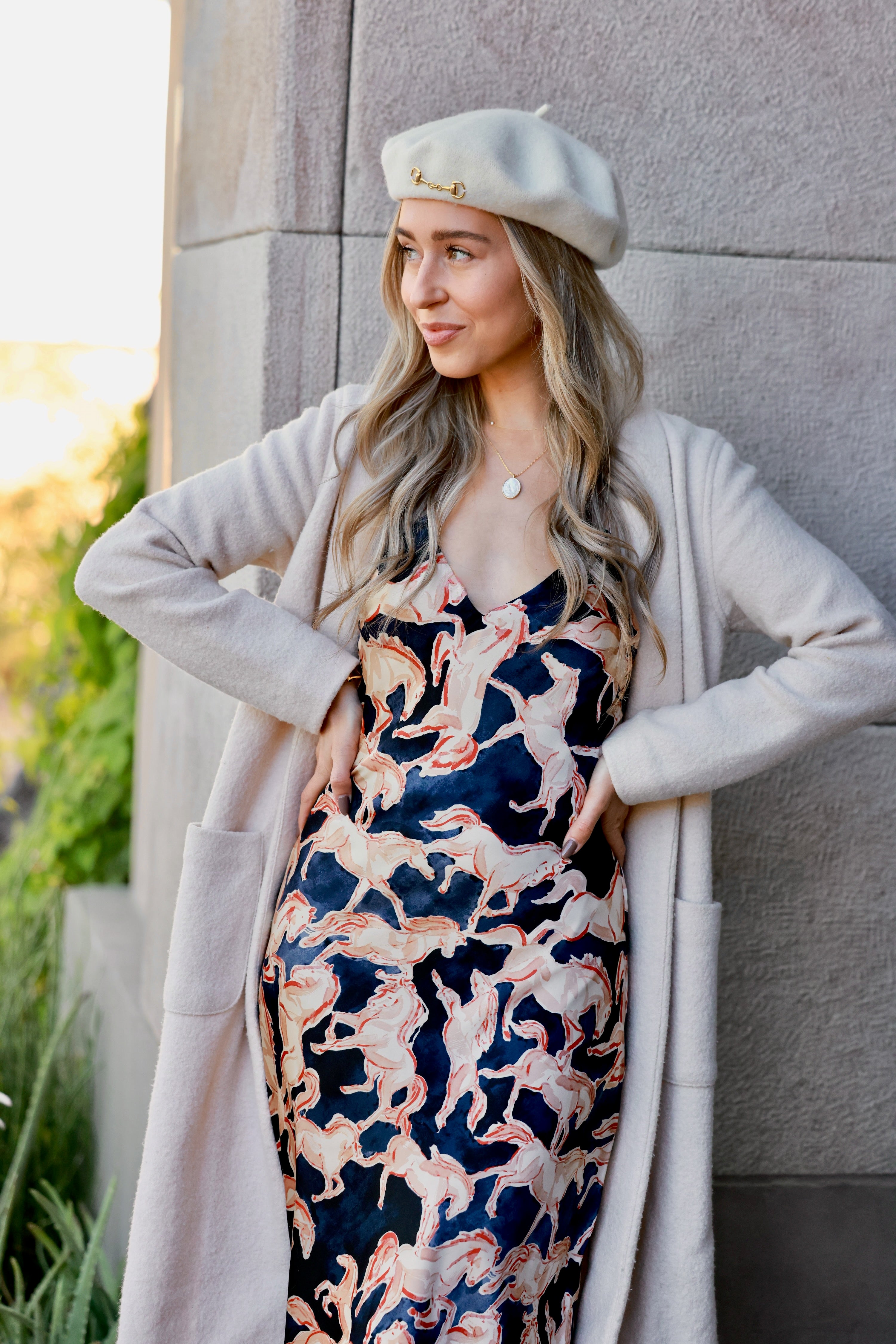 Ivory Lola Bit Beret crafted from 100% wool and embellished with a polished gold horse bit accent. Elegant equestrian-inspired accessory that adds refined, horse-girl chic style to any fall or winter outfit.