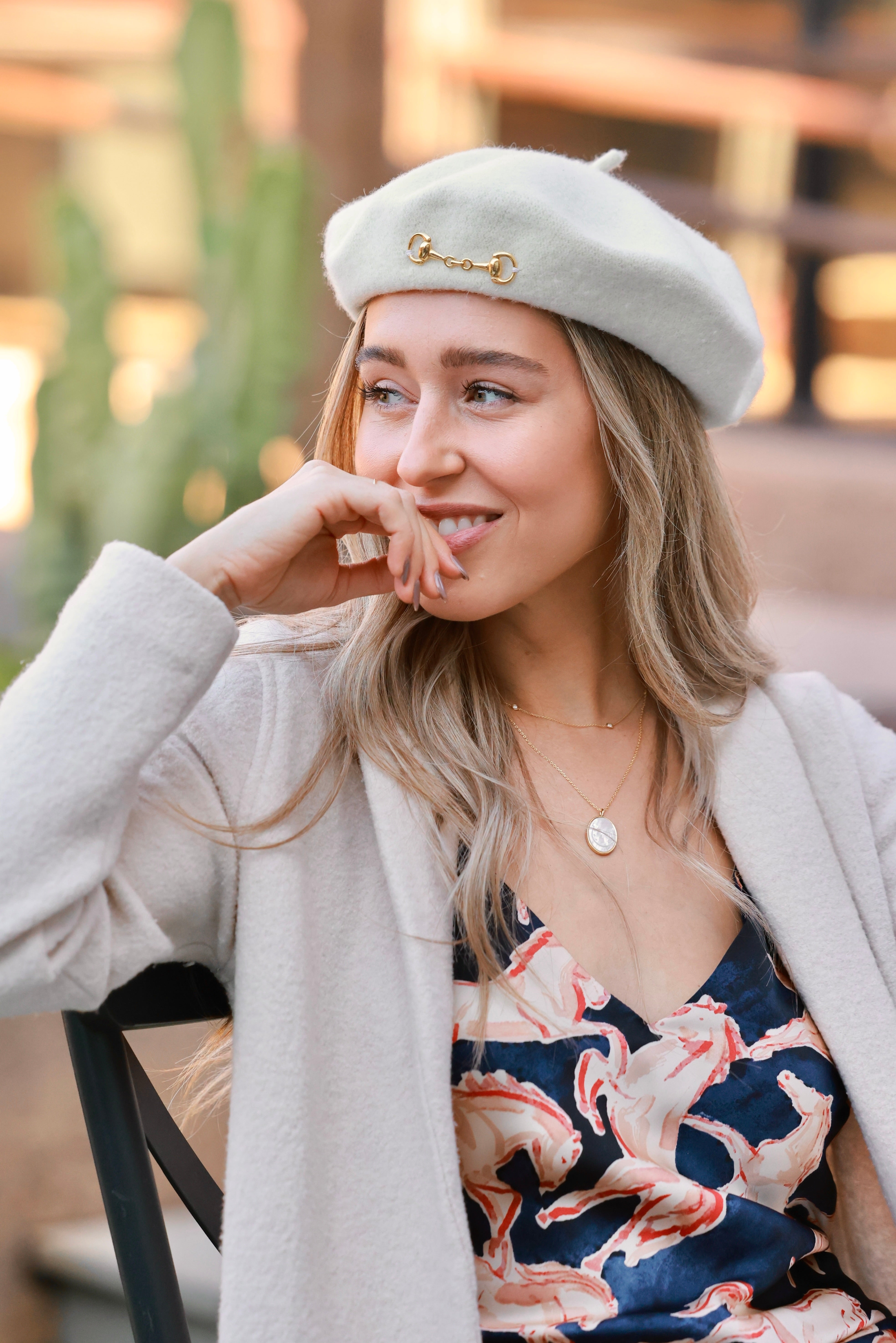 Ivory Lola Bit Beret crafted from 100% wool and embellished with a polished gold horse bit accent. Elegant equestrian-inspired accessory that adds refined, horse-girl chic style to any fall or winter outfit.