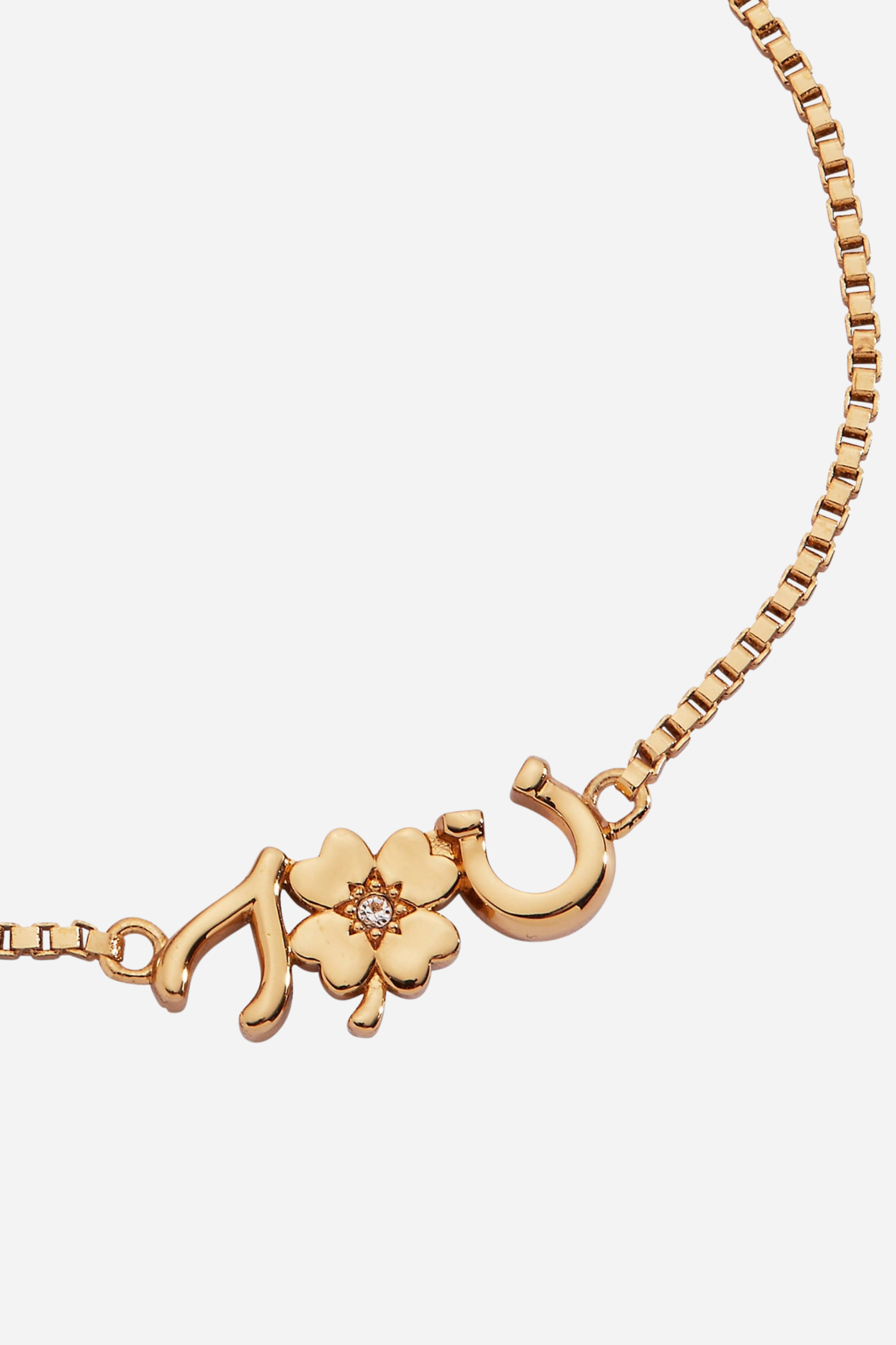 Gold-plated adjustable bolo bracelet featuring lucky charm symbols including a horseshoe, clover, and wishbone with crystal accents.