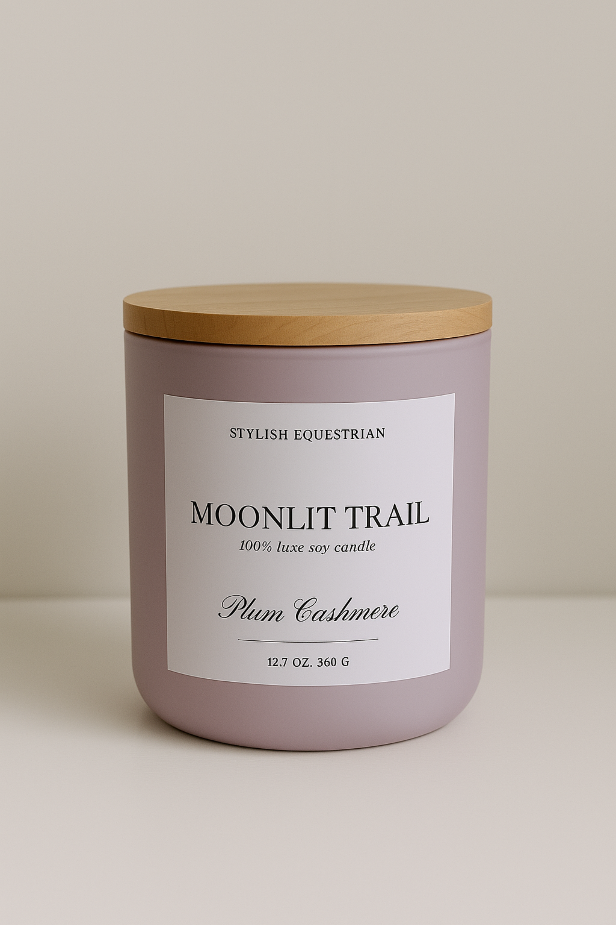 Luxe Signature Candle – Moonlit Trail edition, a handmade 100% soy wax candle in a frosted matte glass vessel with wooden lid. Features a luxurious plum cashmere scent with notes of ripe plum, freesia, warm vanilla, and soft cashmere. Elegant equestrian-inspired home décor accent with 60+ hour burn time. Made in the USA equestrian decor and home accents, horse themed candle, gifts for horse lovers, luxury soy candle, plum cashmere scented candle, Moonlit Trail candle, equestrian home fragrance