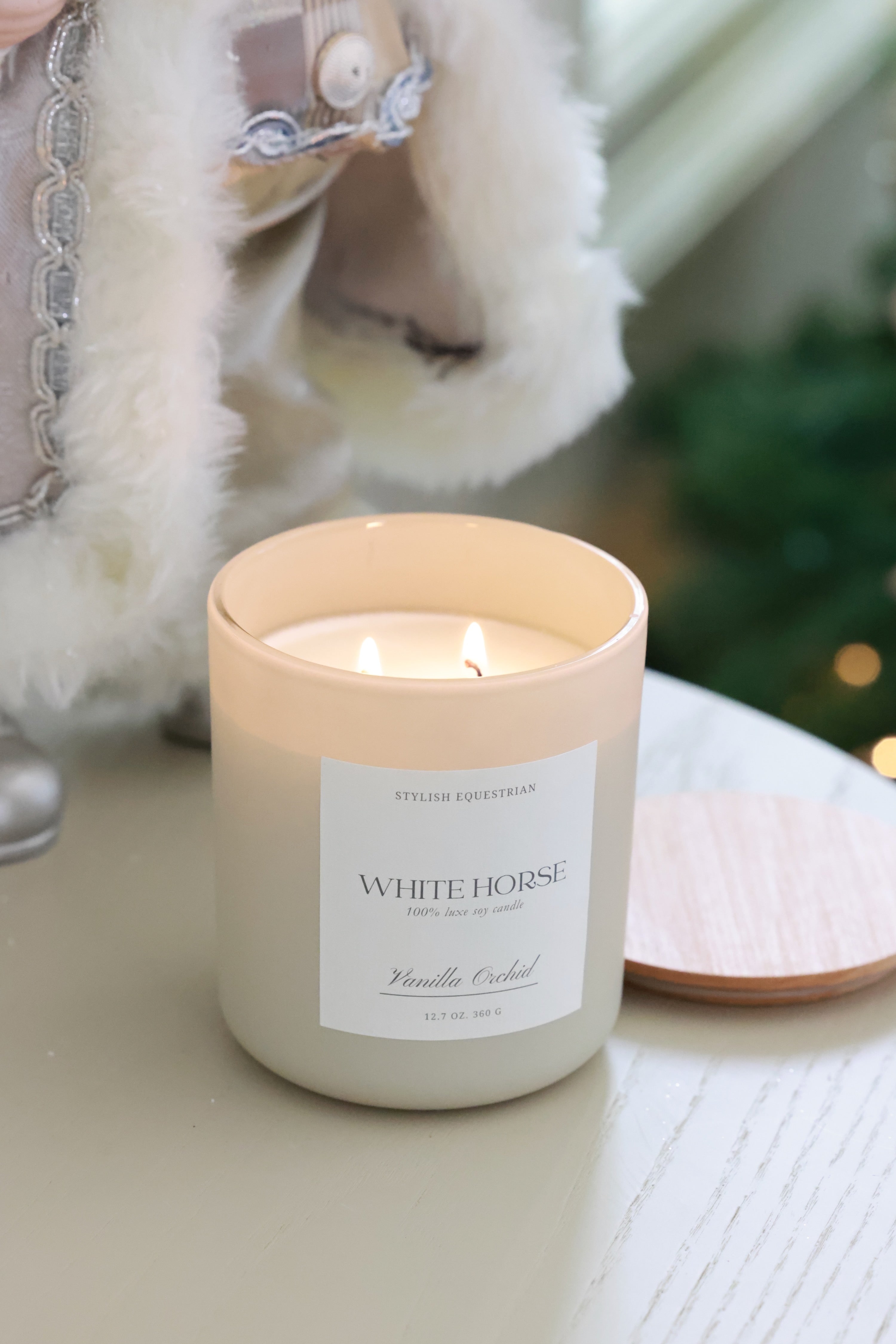 Luxe Signature Candle – White Horse edition, a handmade 100% soy wax candle in a frosted matte glass jar with wooden lid. Features a soothing Vanilla Orchid scent with notes of orange, green leaves, jasmine, sandalwood, and creamy vanilla. Elegant equestrian-inspired home accent with a 60+ hour burn time. Made in the USA. equestrian decor and home accents, horse themed candle, gifts for horse lovers, luxury soy candle, vanilla orchid candle, White Horse candle, equestrian home fragrance