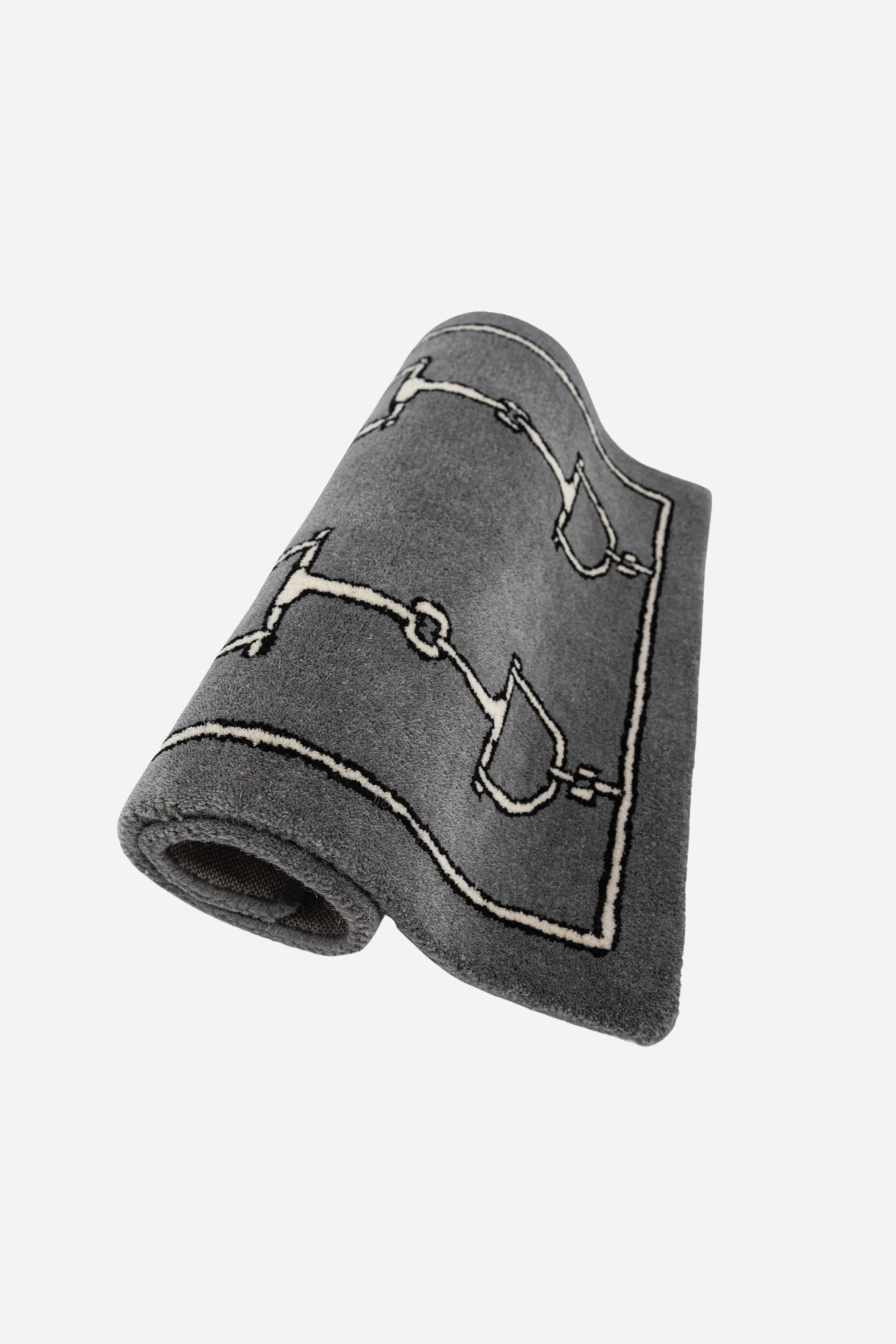 Gray rug with a pattern of bridles and bits in two vertical rows. Framed by a simple border, the design adds a touch of elegance and classic style. equestrian home décor, horse themed rug, luxury equestrian barn accessories, tufted wool rug, saddle room décor, barn entryway mat, horse bit design rug, equestrian gift ideas, stylish horse barn décor