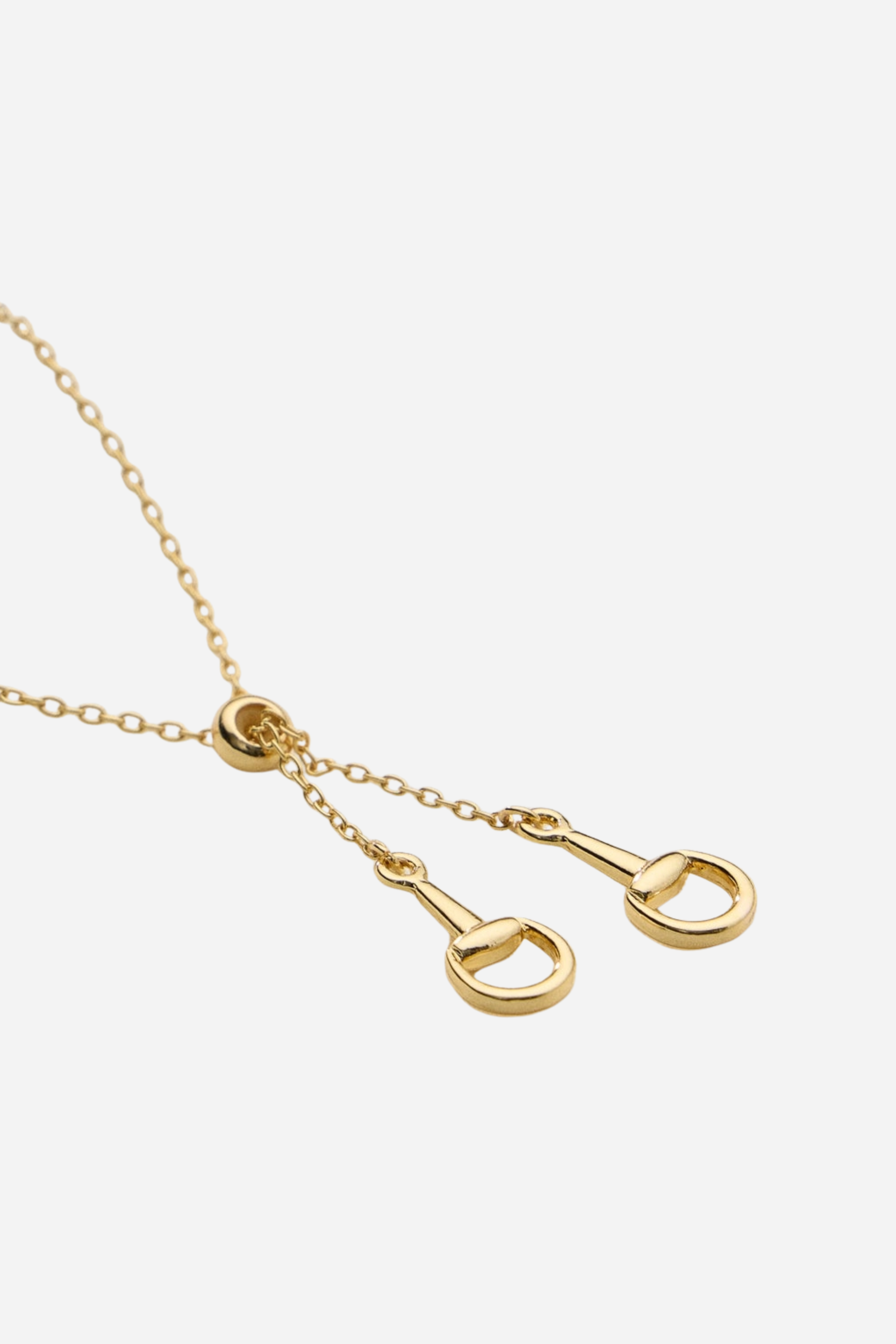 Gold equestrian necklace with adjustable sliding bead and drop pendants, dainty 18k gold horse girl jewelry, minimalist horseshoe-inspired necklace, elegant gift for horse lovers.