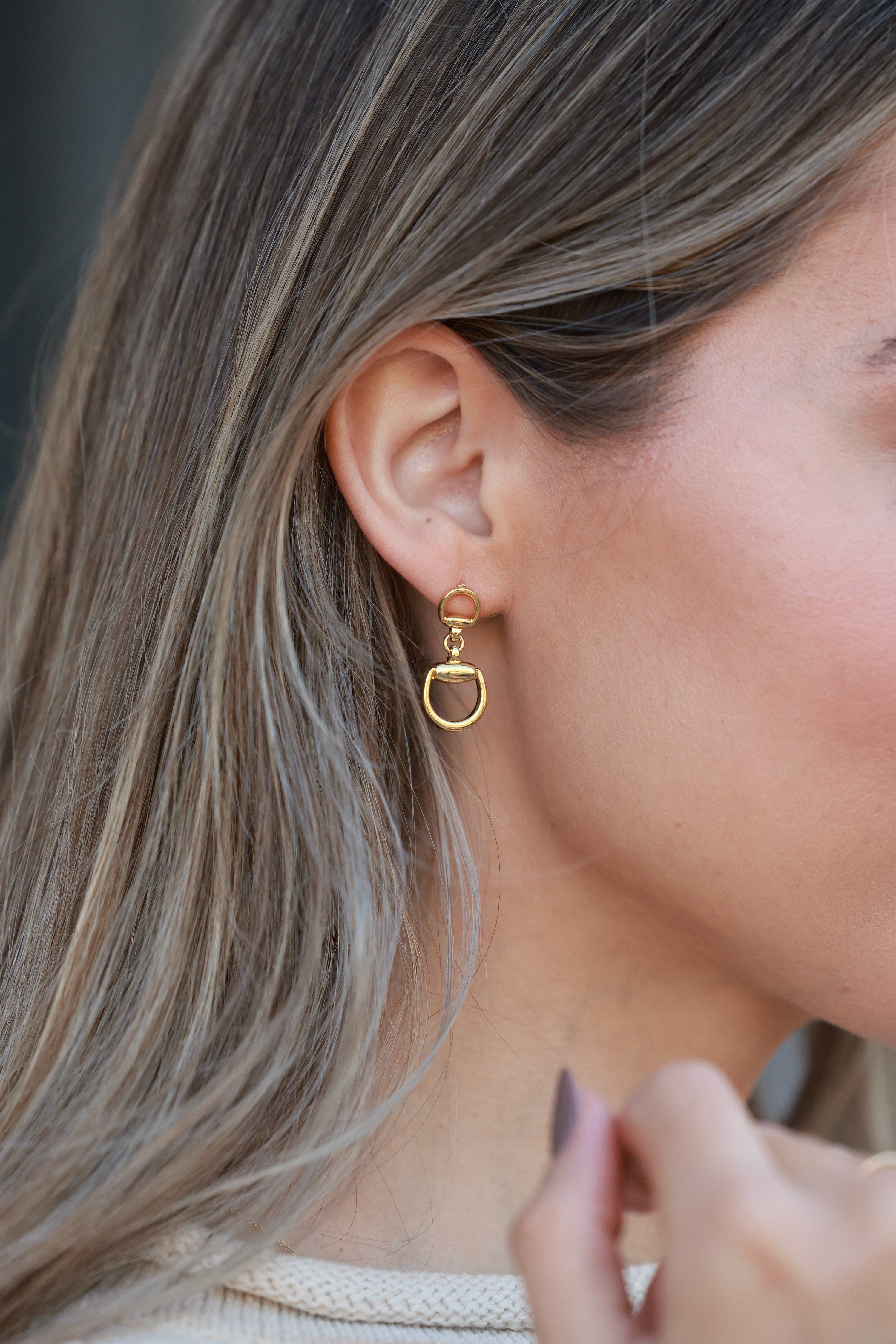 Gold d-ring drop earrings with interlocking circular links, minimalist 18k gold statement jewelry, modern equestrian-inspired earrings for women.