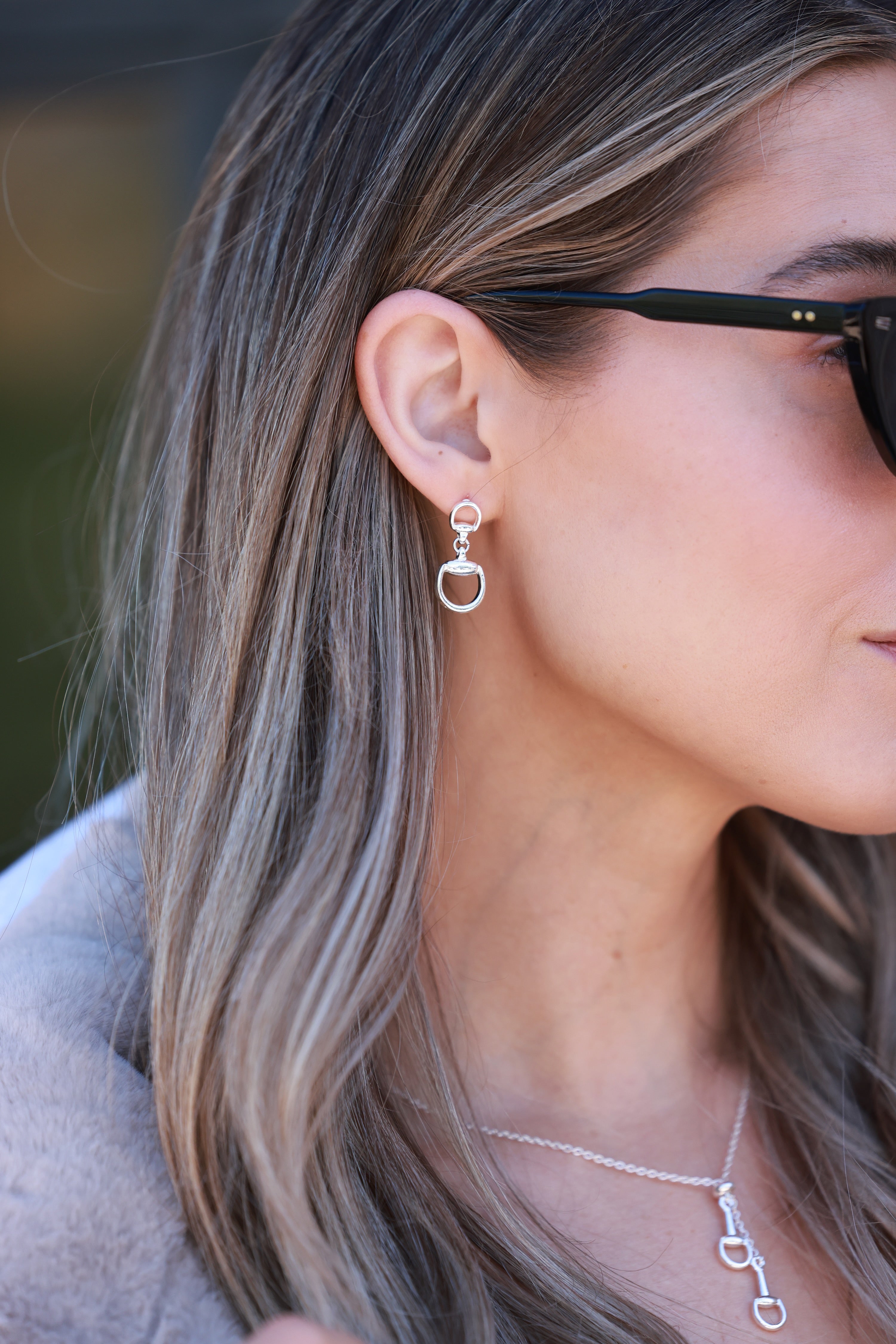 Silver equestrian drop earrings with interlocking D-ring design, minimalist horse bit jewelry, lightweight statement earrings for women, elegant gift for horse lovers.