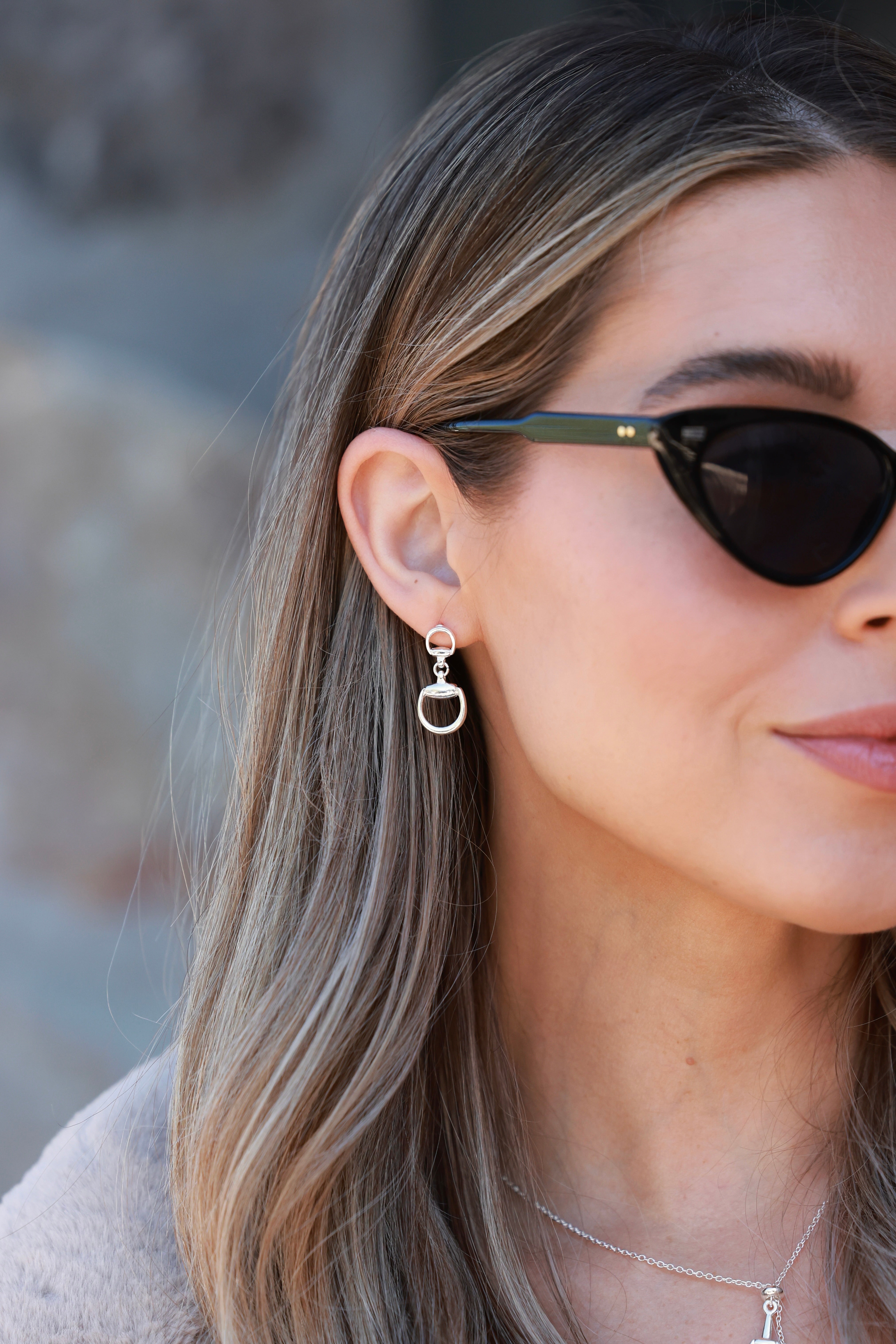 Silver equestrian drop earrings with interlocking D-ring design, minimalist horse bit jewelry, lightweight statement earrings for women, elegant gift for horse lovers.