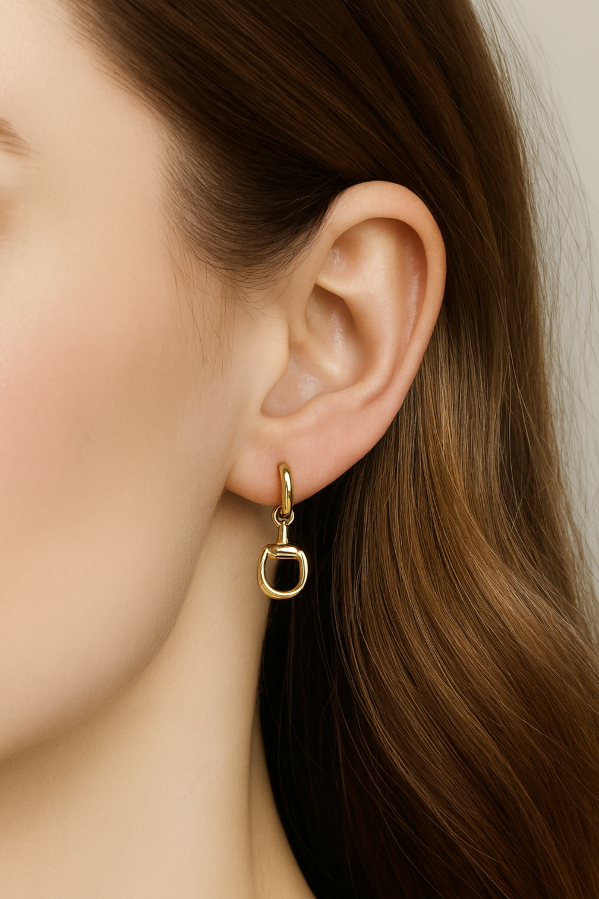 Gold equestrian huggie hoop earrings with stirrup design, lightweight 18k gold horse bit jewelry, dainty horse girl earrings, elegant gift for equestrian lovers.