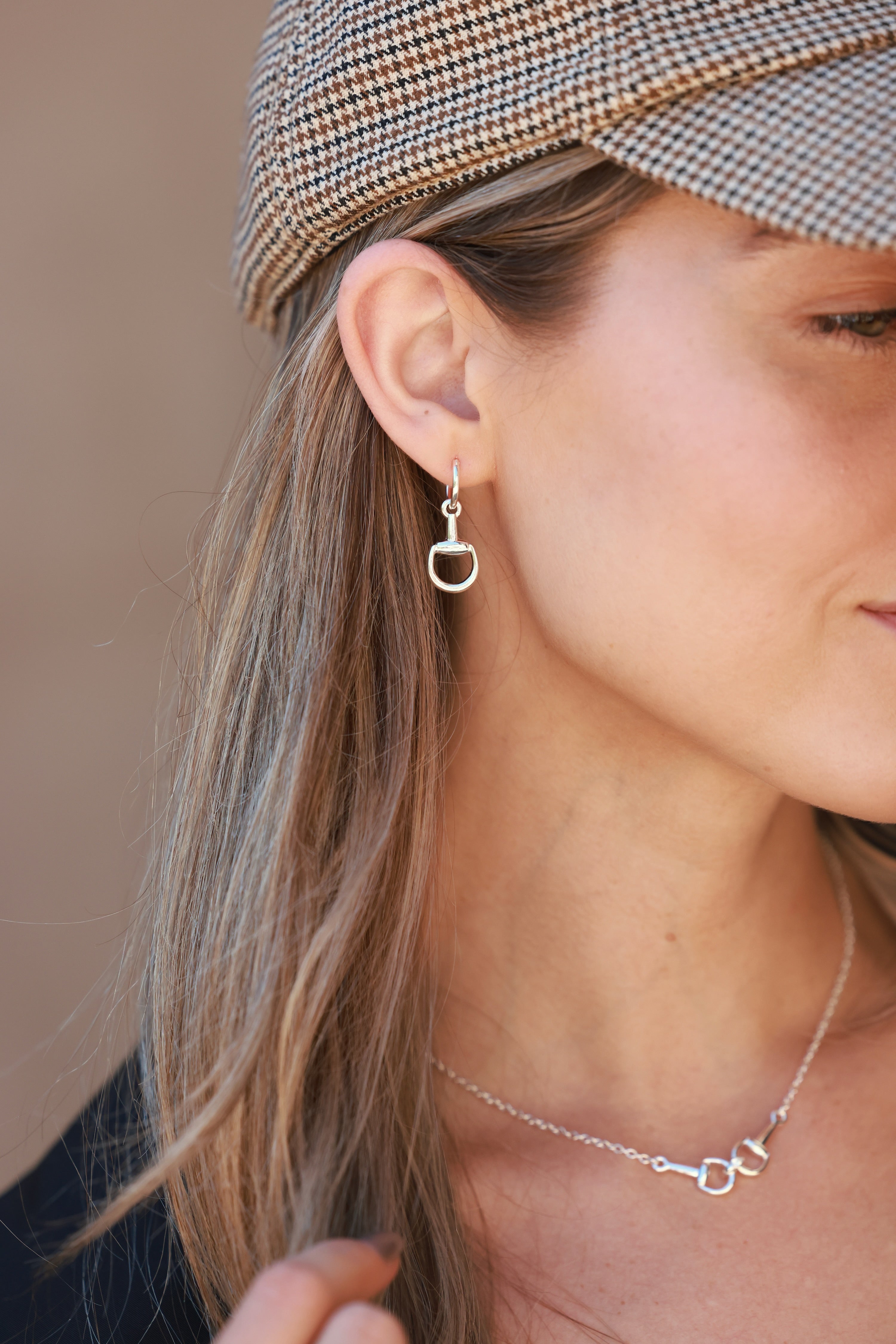 Silver equestrian huggie hoop earrings with stirrup design, lightweight horse bit jewelry, dainty horse girl earrings, elegant gift for equestrian lovers.