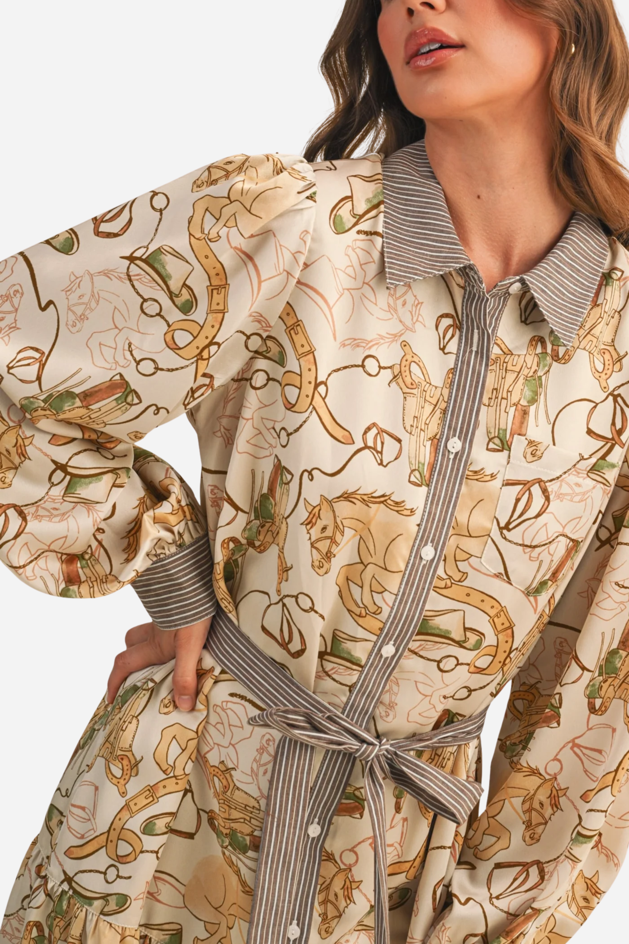 Woman wearing a patterned dress with a belt against a beige background - print mini dress, &merci exclusive, Cowgirl print dress, Equestrian-inspired dress, Fall rodeo outfit