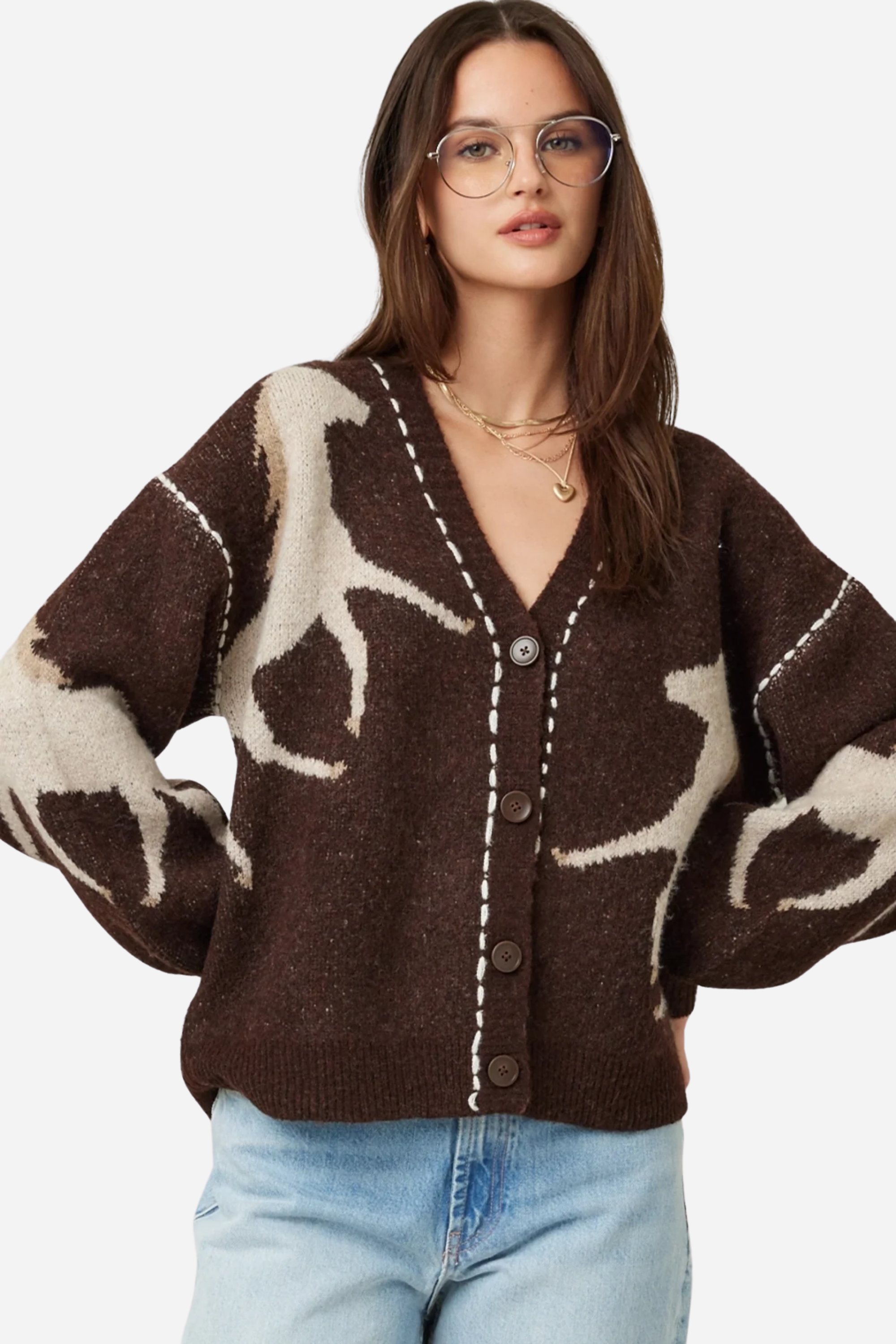 Woman wearing a brown cardigan with deer pattern and light blue jeans on a plain background - Horse knit cardigan, Brown western cardigan, Cowgirl graphic sweater, Oversized horse print cardigan, Equestrian boutique knitwear