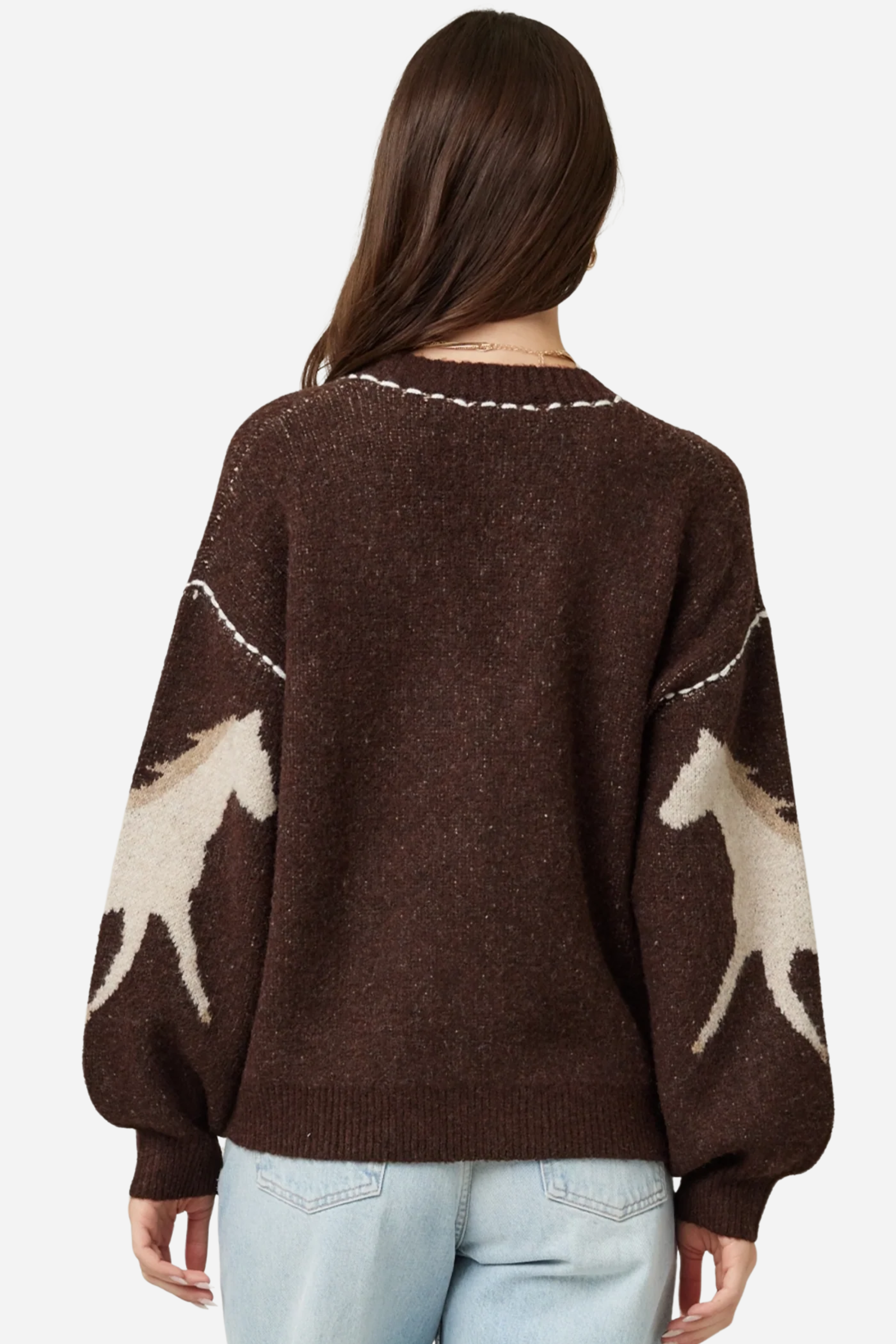 Woman wearing a brown cardigan with deer pattern and light blue jeans on a plain background - Horse knit cardigan, Brown western cardigan, Cowgirl graphic sweater, Oversized horse print cardigan, Equestrian boutique knitwear