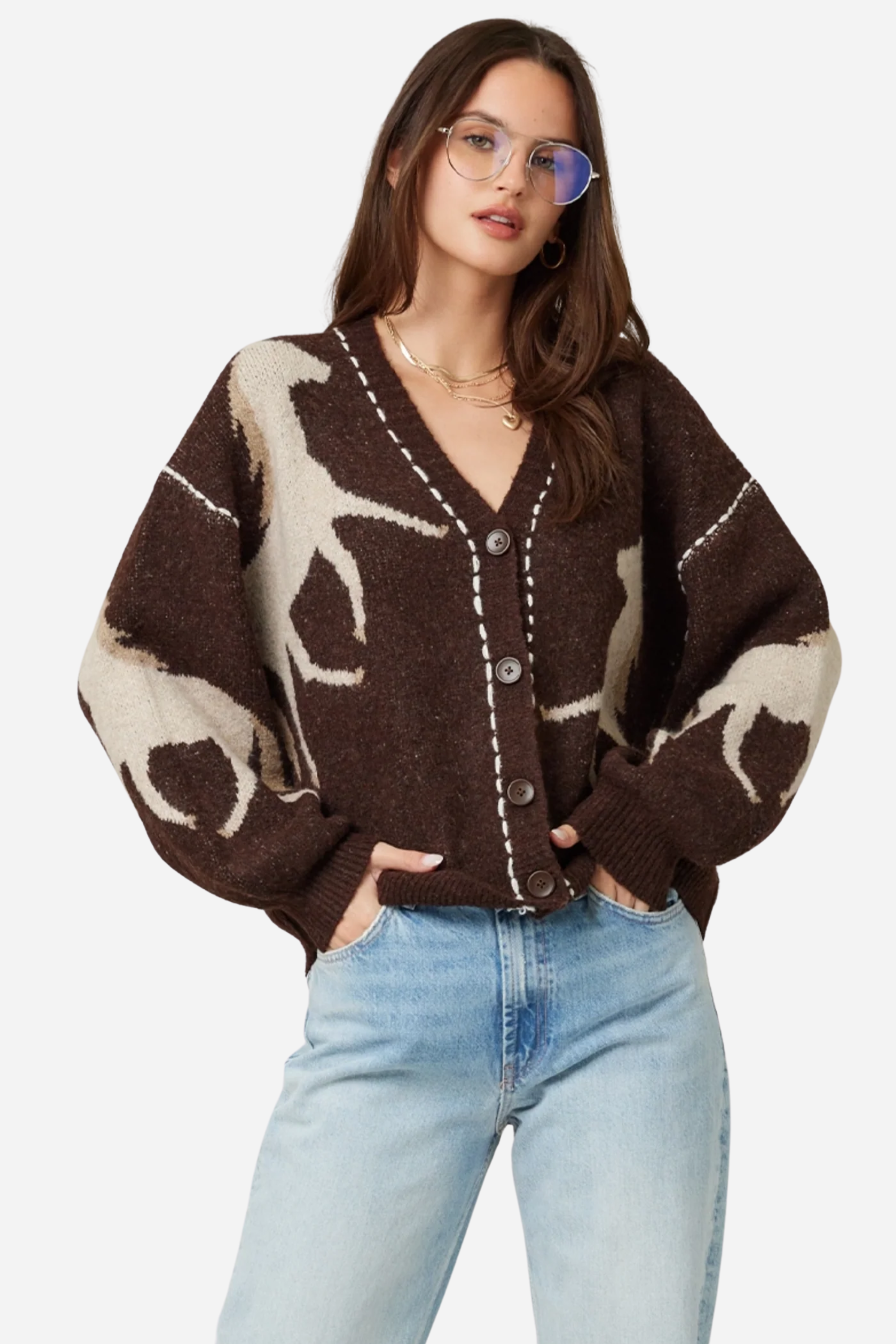 Woman wearing a brown cardigan with deer pattern and light blue jeans on a plain background - Horse knit cardigan, Brown western cardigan, Cowgirl graphic sweater, Oversized horse print cardigan, Equestrian boutique knitwear