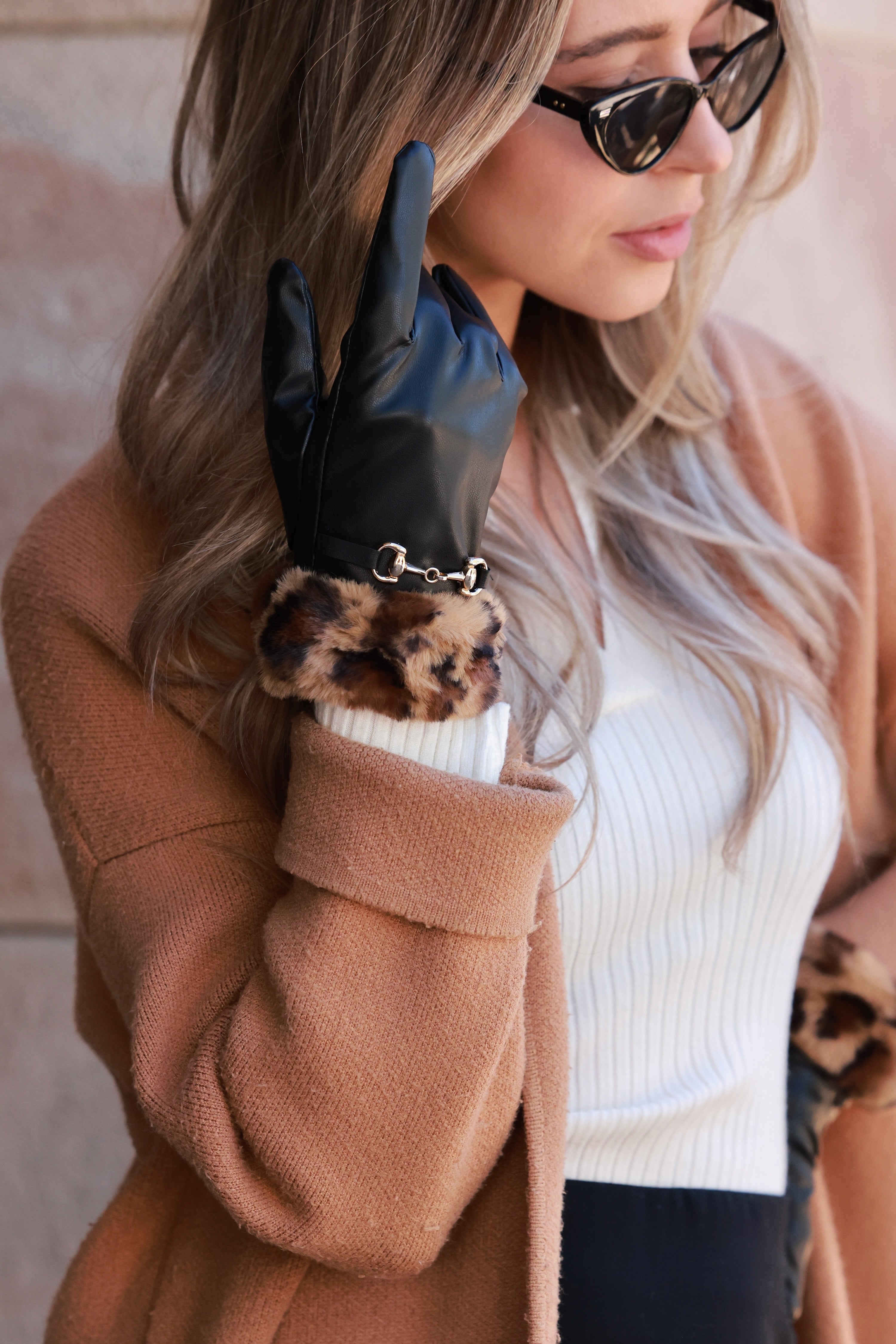 Meredith Horse Bit Gloves crafted from supple polyurethane leather with soft faux-fur lining, chic leopard print cuffs, and polished gold horse bit detail. Elegant equestrian cold-weather accessory combining warmth, style, and sophistication.