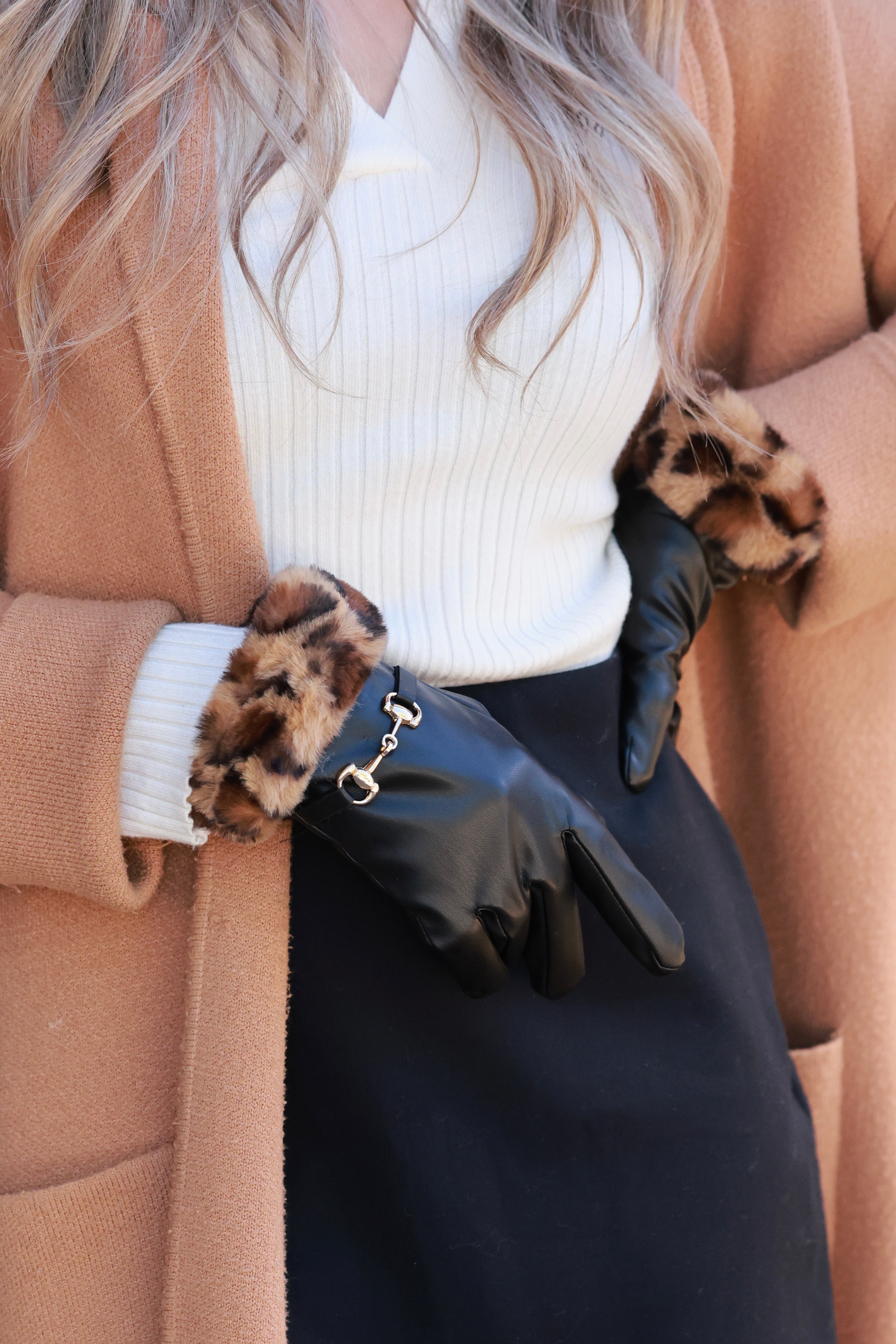 Meredith Horse Bit Gloves crafted from supple polyurethane leather with soft faux-fur lining, chic leopard print cuffs, and polished gold horse bit detail. Elegant equestrian cold-weather accessory combining warmth, style, and sophistication.