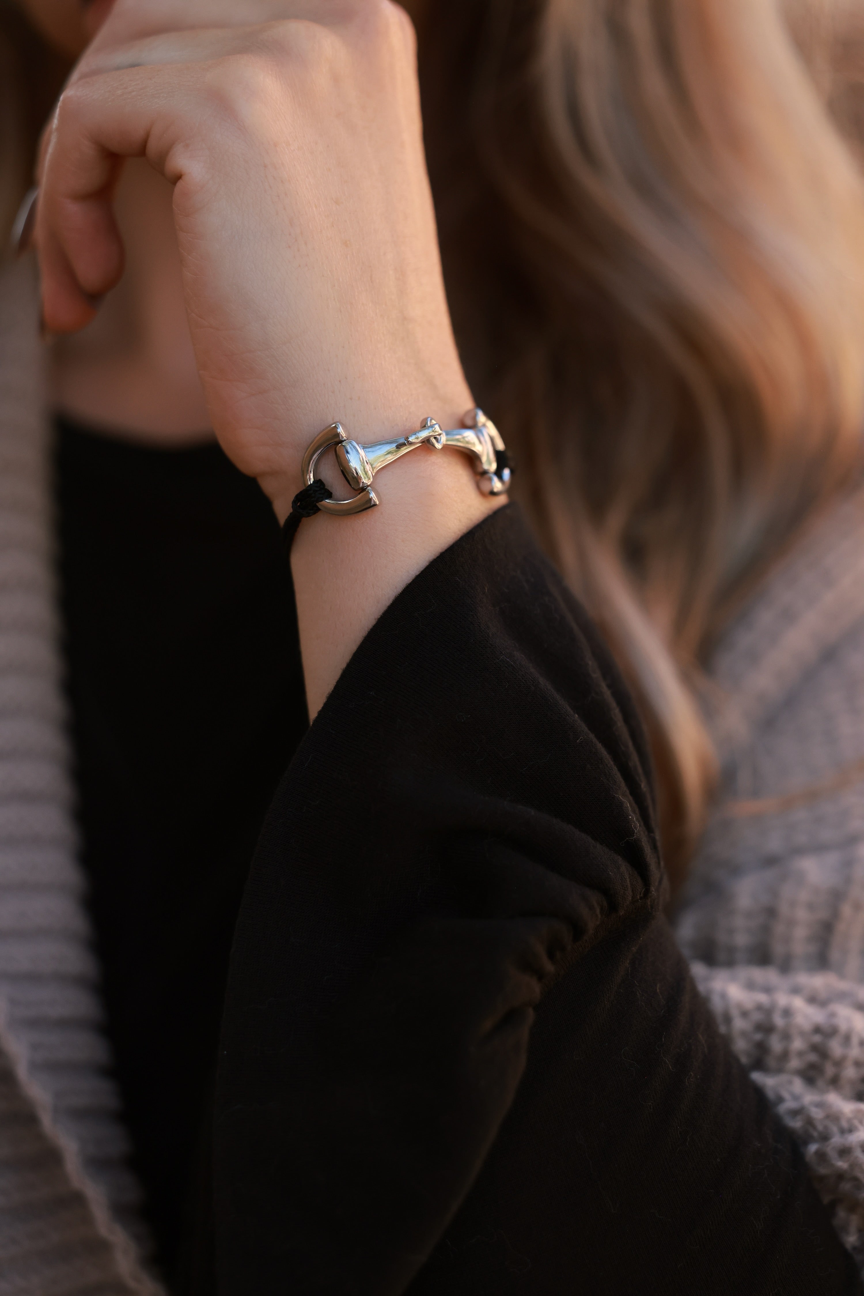 Black Pony Bracelet from Stylish Equestrian x Dimacci, handmade in Germany with an adjustable nylon band and polished stainless steel snaffle bit accent. A dainty equestrian-inspired bracelet perfect for layering or gifting to horse lovers.