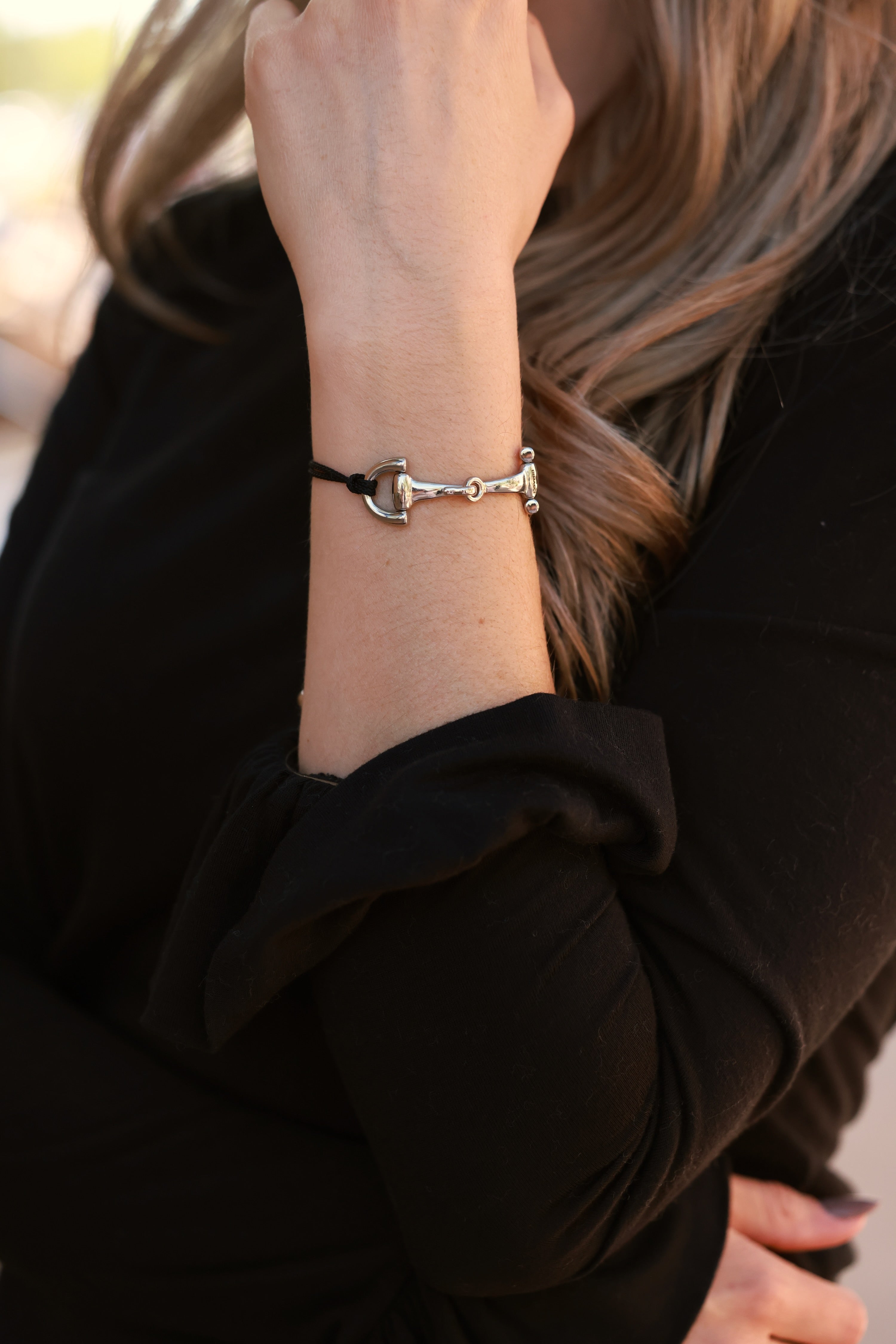 Black Pony Bracelet from Stylish Equestrian x Dimacci, handmade in Germany with an adjustable nylon band and polished stainless steel snaffle bit accent. A dainty equestrian-inspired bracelet perfect for layering or gifting to horse lovers.
